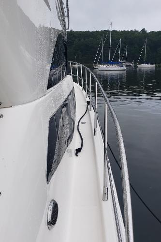 Side view of 2010 Meridian 441 Sedan yacht on calm water.