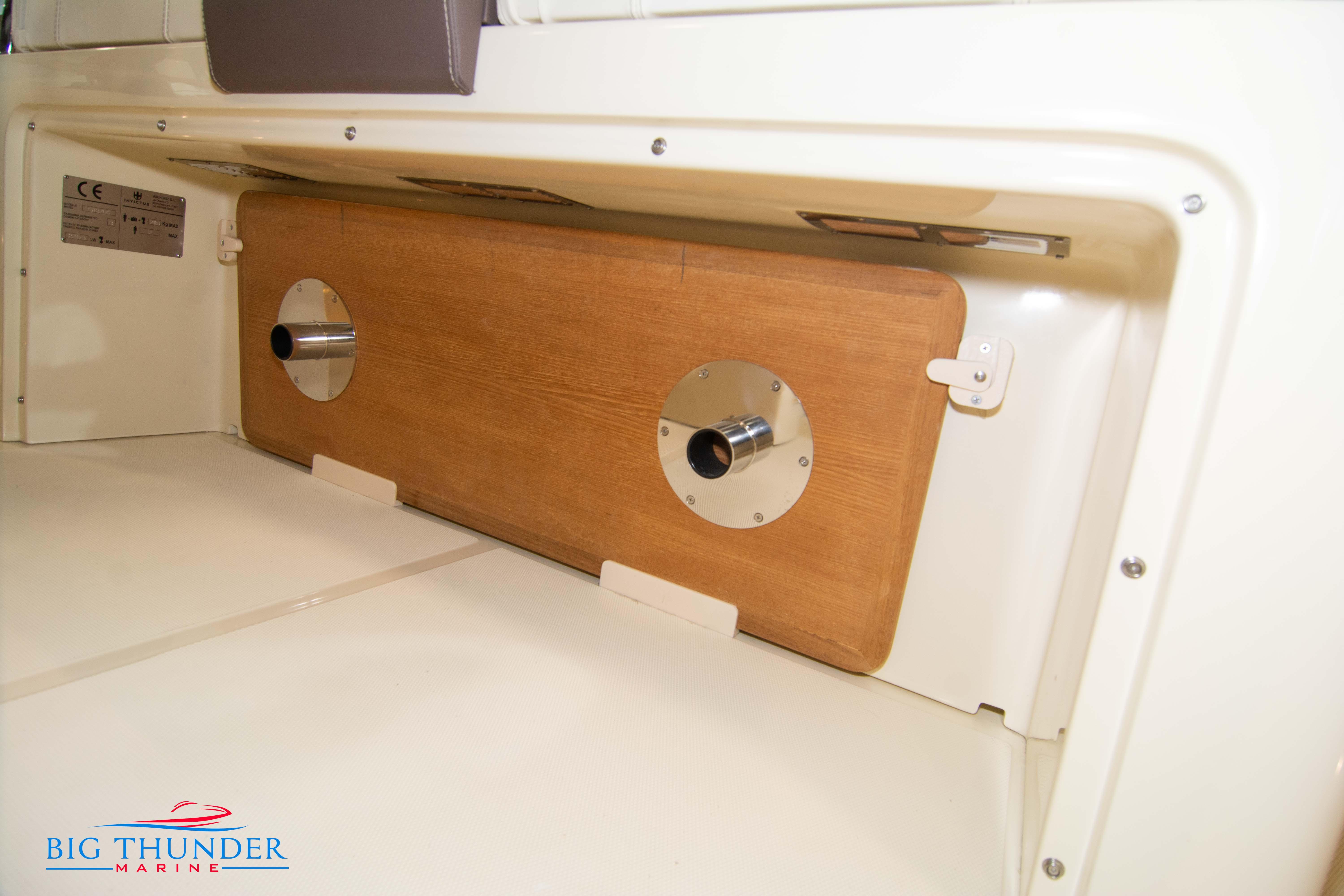 2024 Invictus GT320S storage compartment with wooden panel and metal fixtures.