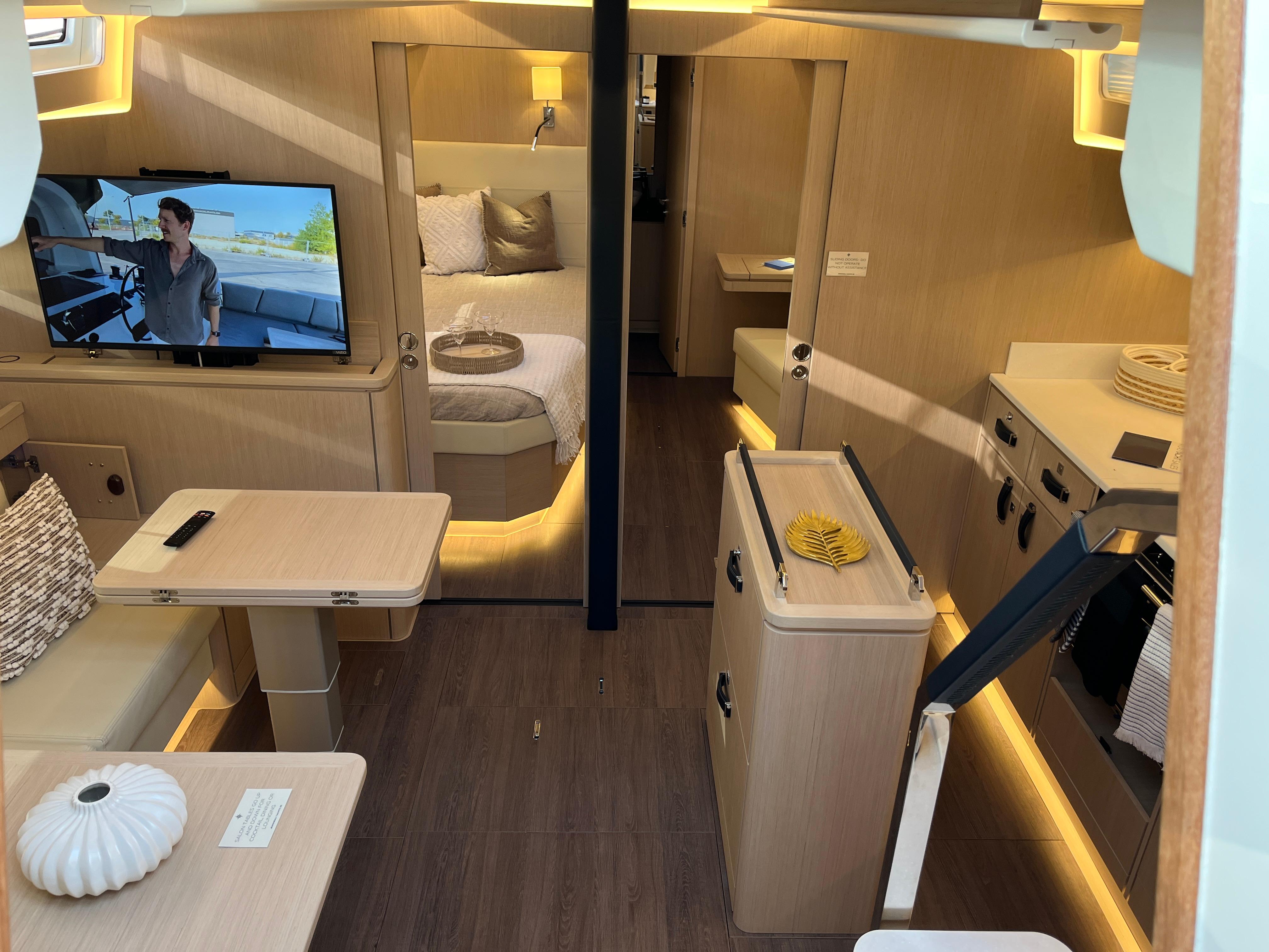 Luxurious interior of 2024 Jeanneau 55 yacht with modern amenities and cozy living space.