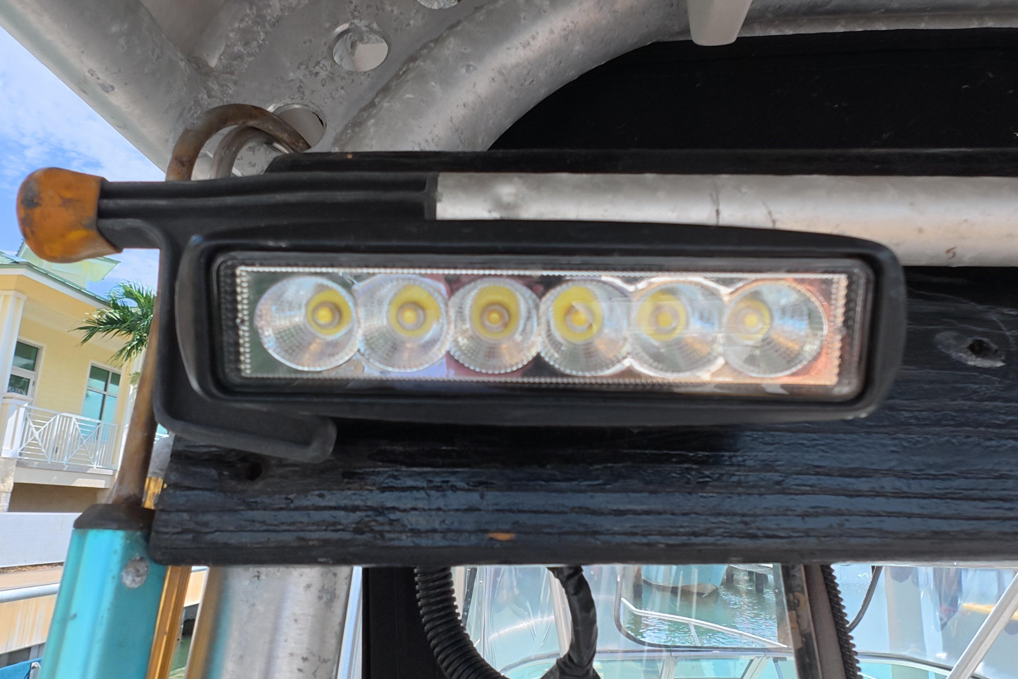 Close-up of LED light on 1992 Luhrs 300 Tournament boat, docked near a building.
