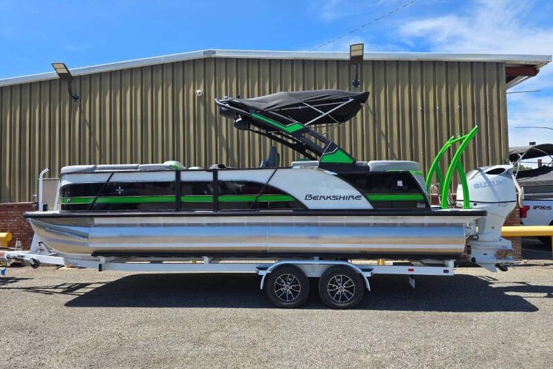 2026 Berkshire STS Arch Performance Series pontoon boat on trailer, parked outdoors.