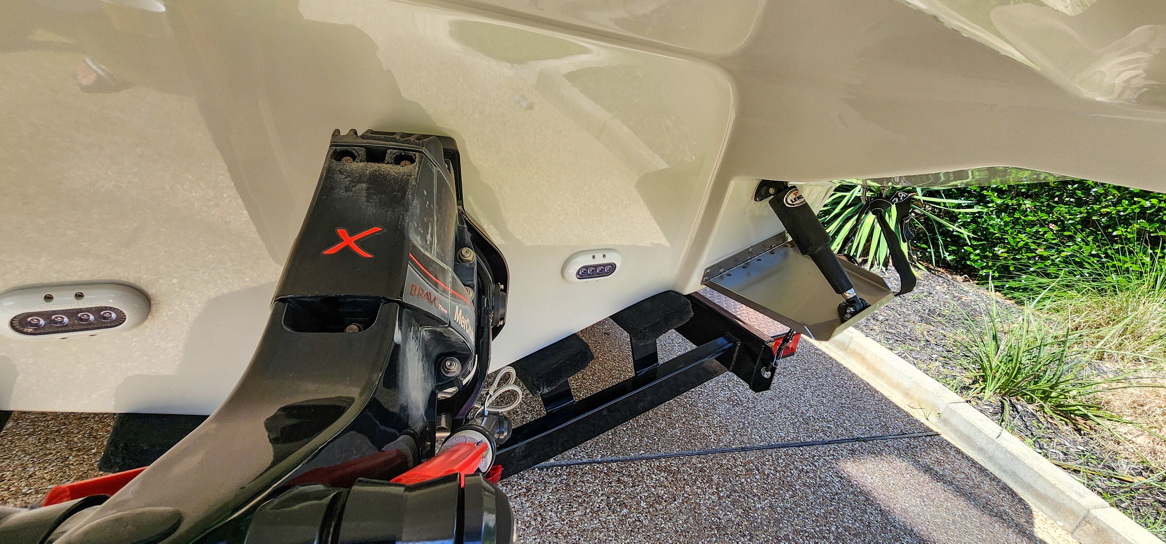 Close-up of the stern of a Crownline 285SS boat with engine and trailer.