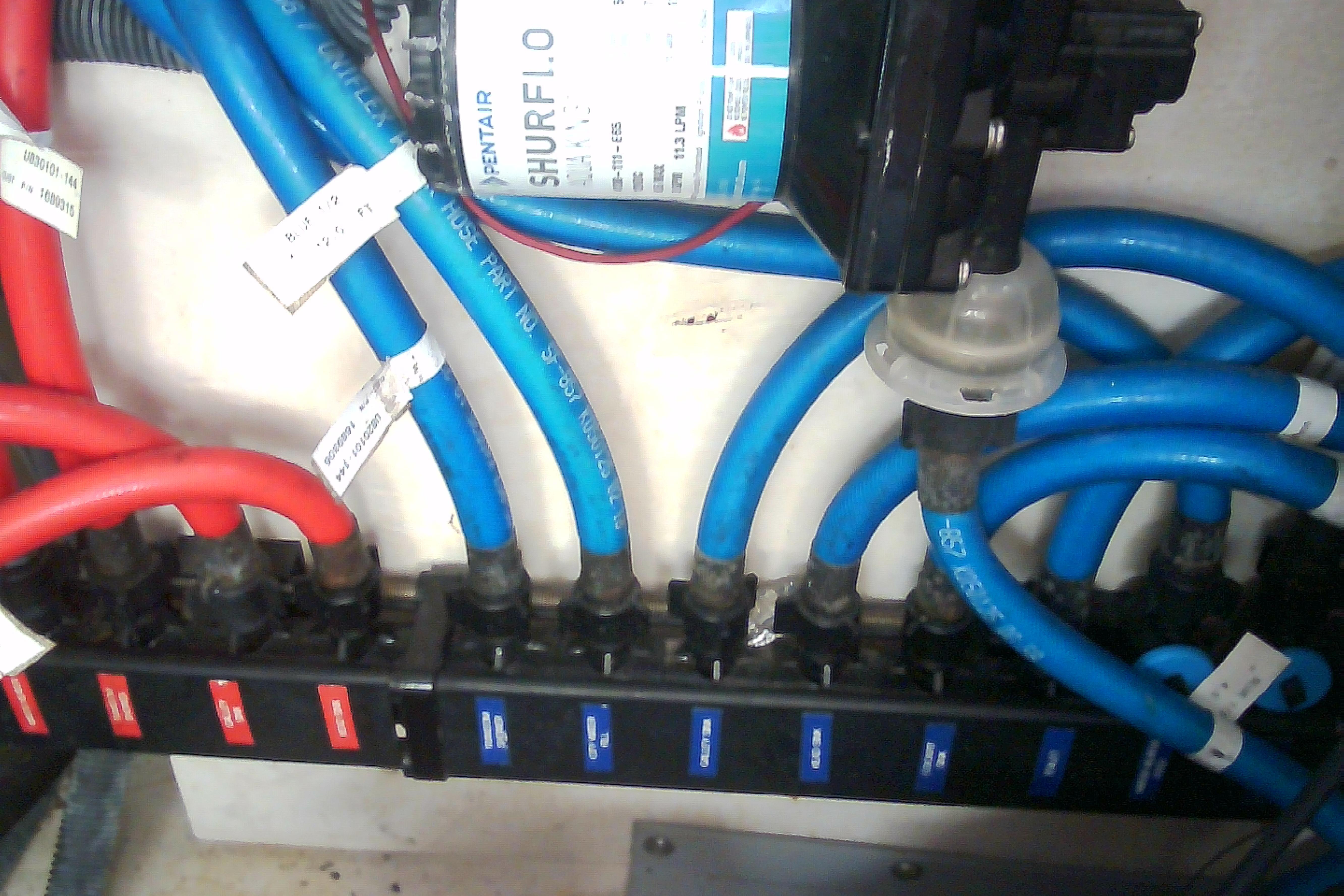 Electrical wiring and water pump system in a 2005 Sea Ray 300 Sundancer boat.