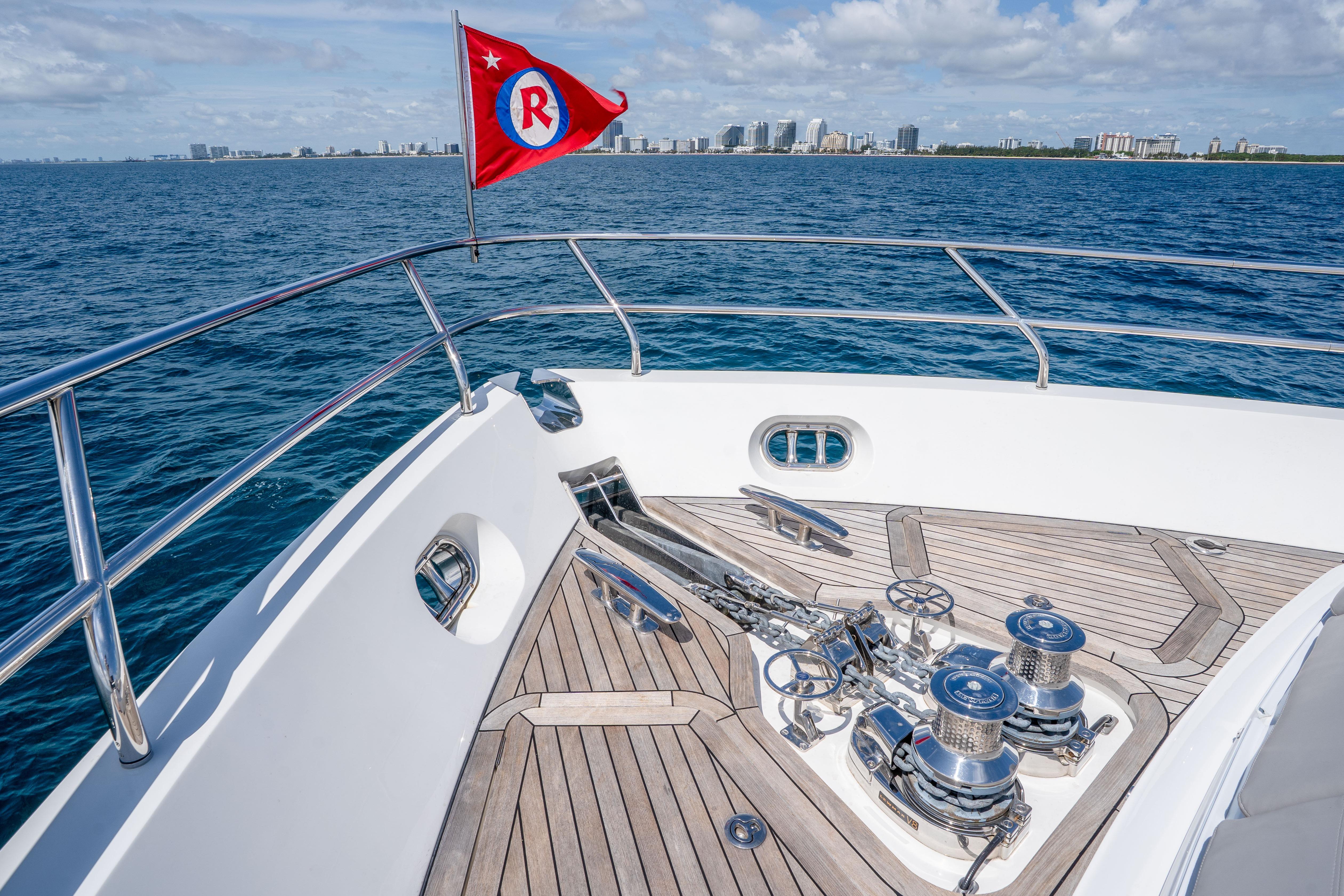 Bow of 2020 Princess Y85 yacht with city skyline in background.