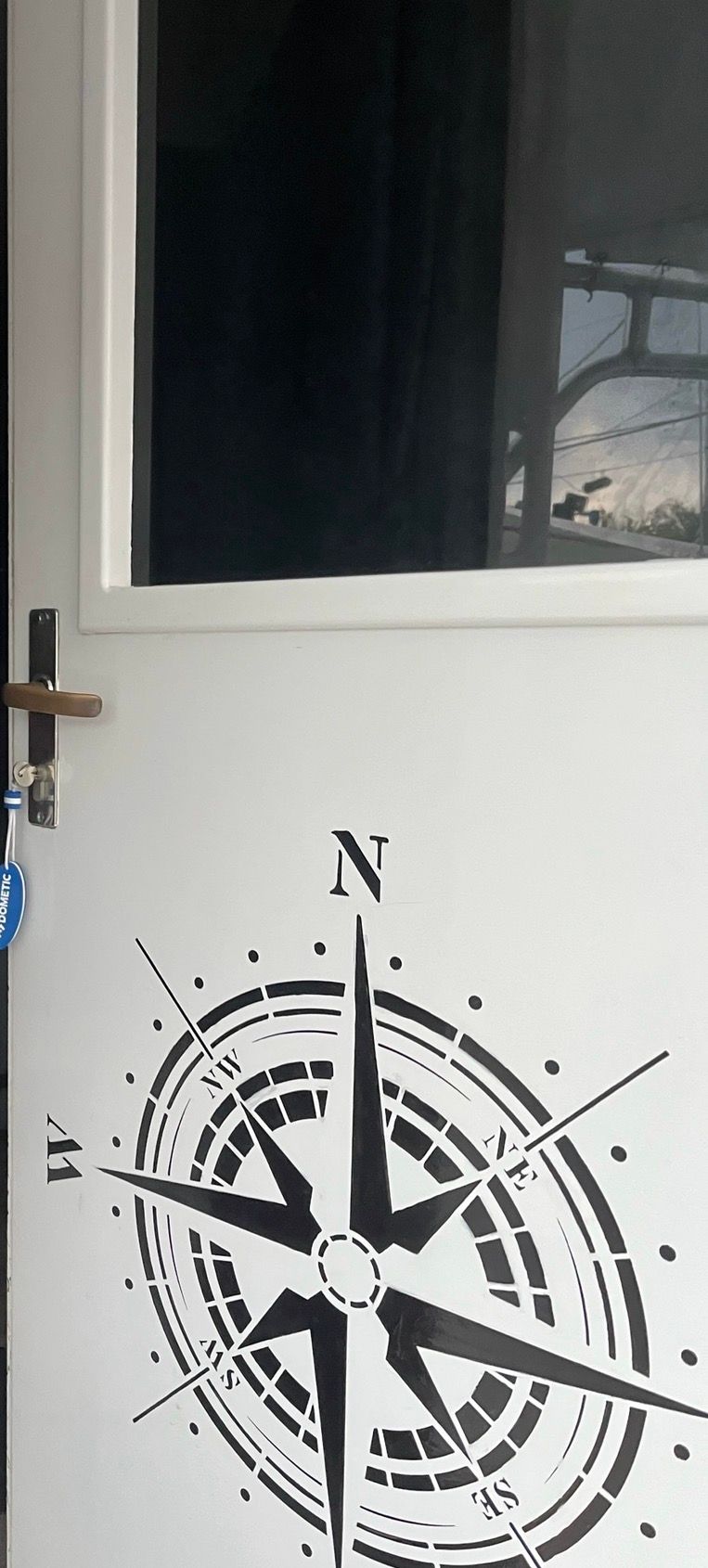 Door with compass rose design on a 1979 Hatteras sport fishing boat.