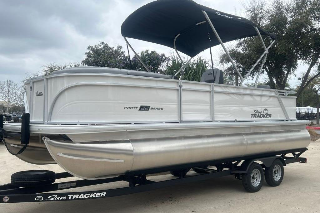 2026 Sun Tracker Party Barge 22 RF DLX pontoon boat on trailer, ready for adventure.