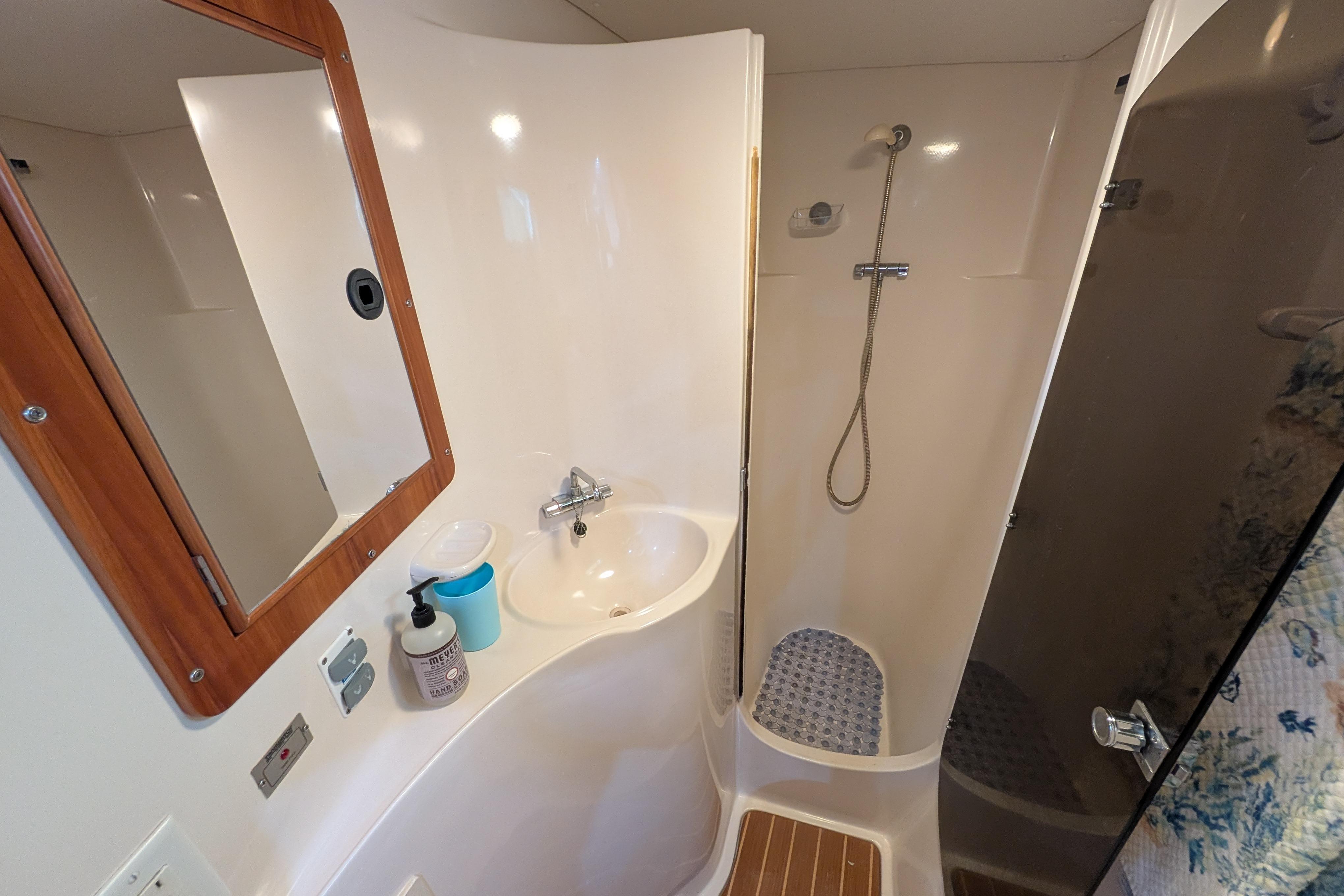 Bathroom interior of 2004 PDQ 34 Powercat, featuring shower and sink area.