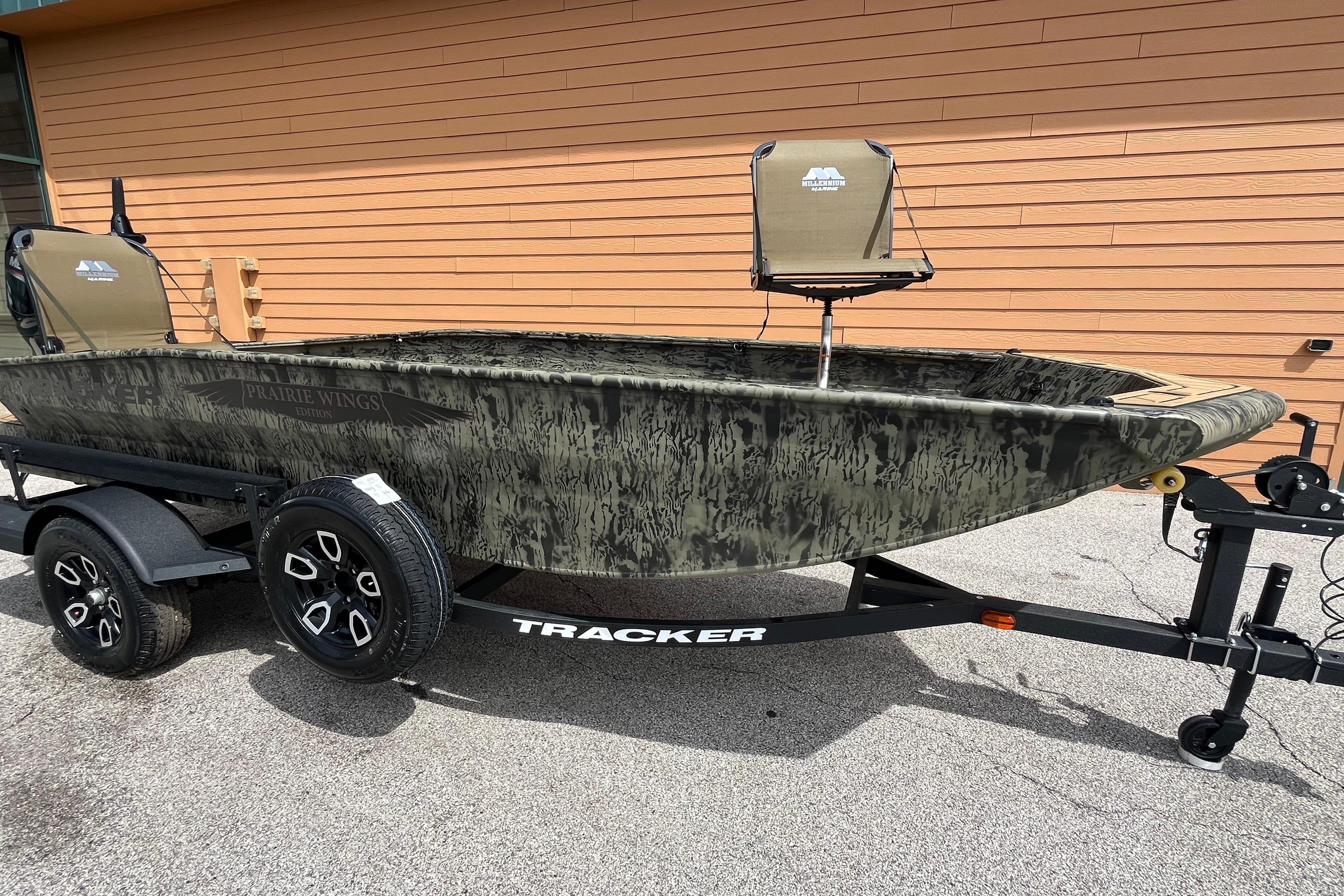 2026 Tracker Grizzly 1650 T Prairie Wings Edition boat on trailer, camo design.
