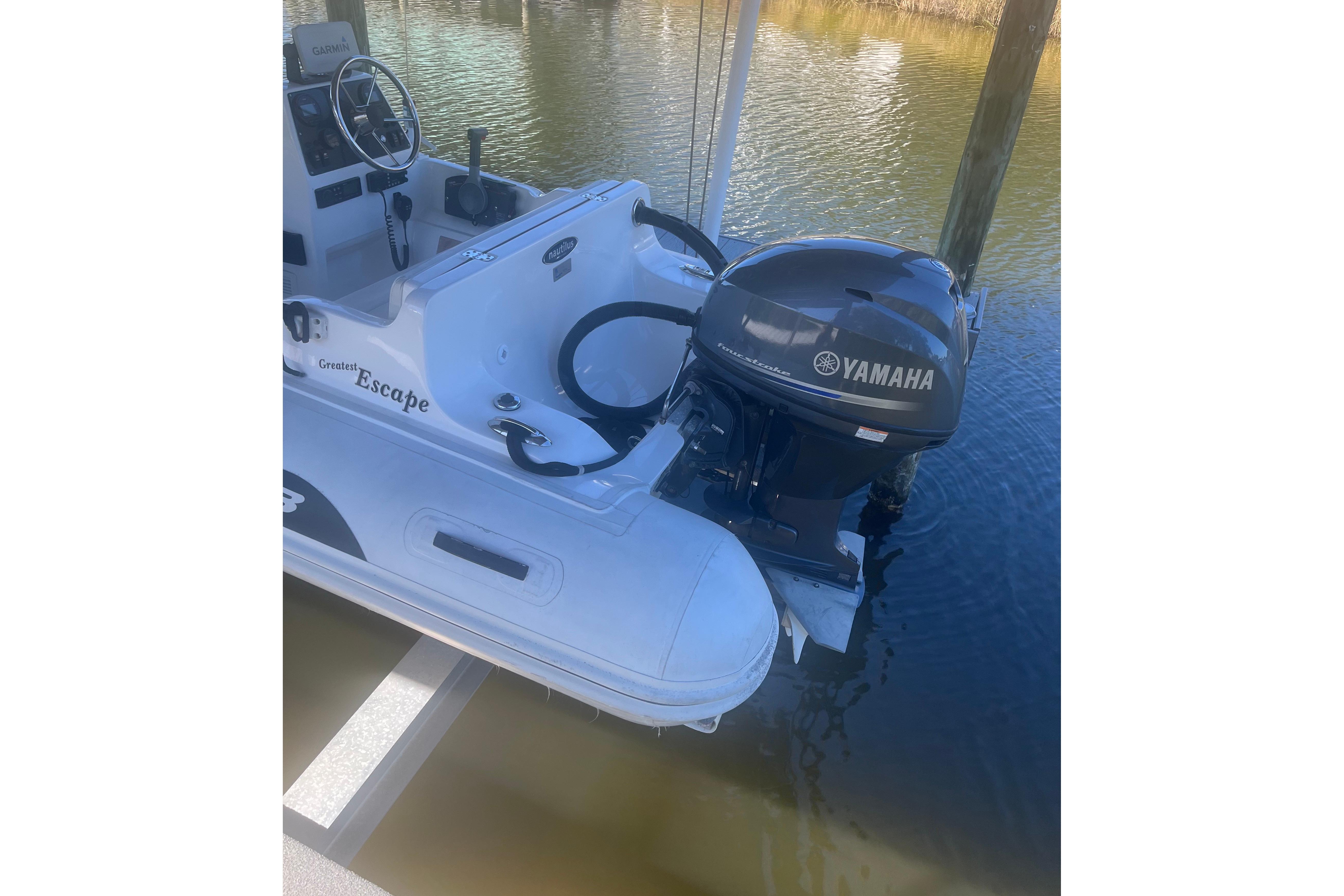 2012 AB Inflatables Nautilus 12 DLX with Yamaha outboard motor docked on water.