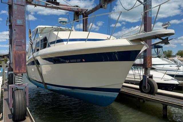 1980 Chris-Craft 381 Catalina yacht in dry dock, showcasing classic design and blue accents.