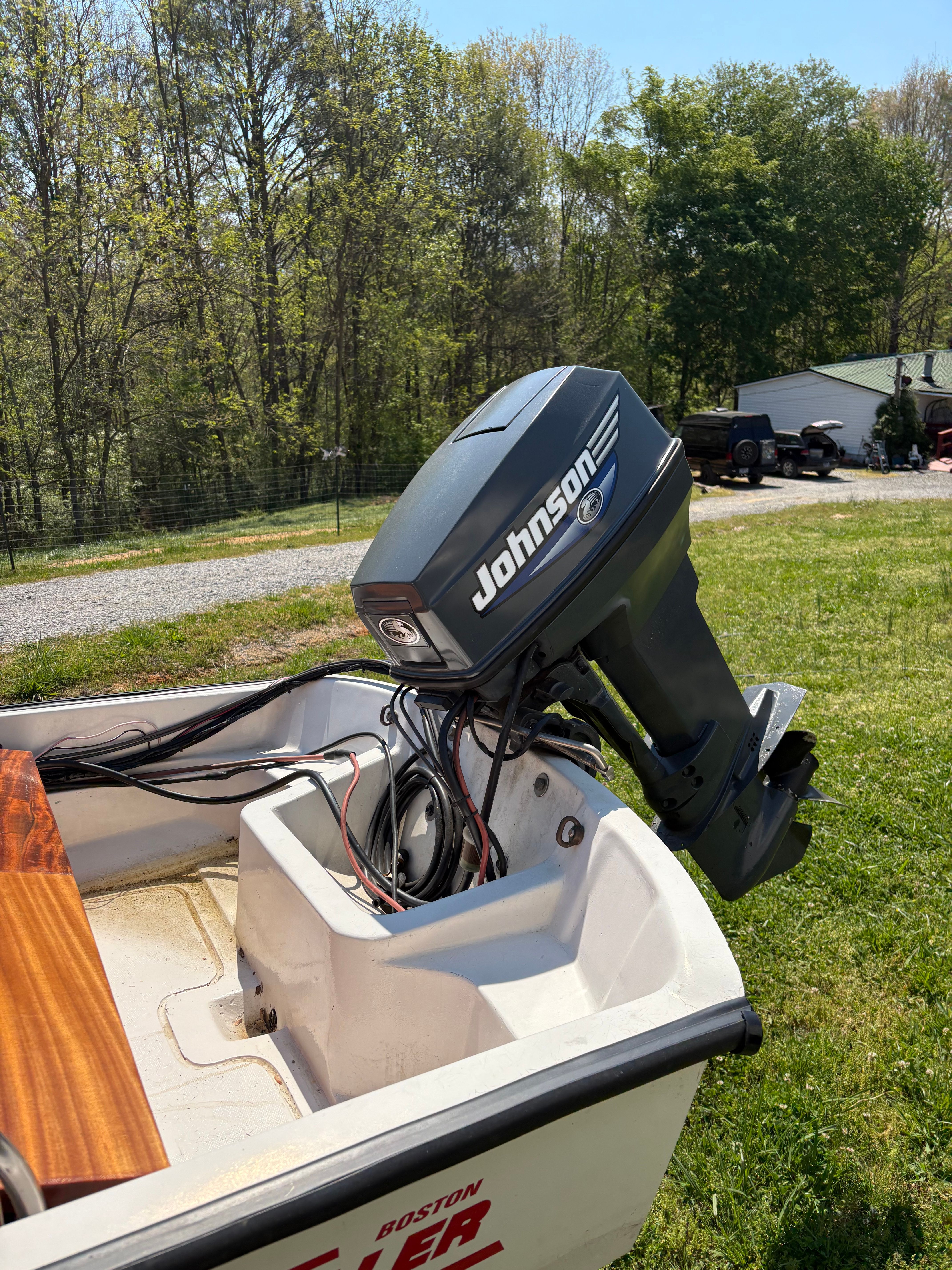 1977 Boston Whaler 13 with Johnson outboard motor outdoors.