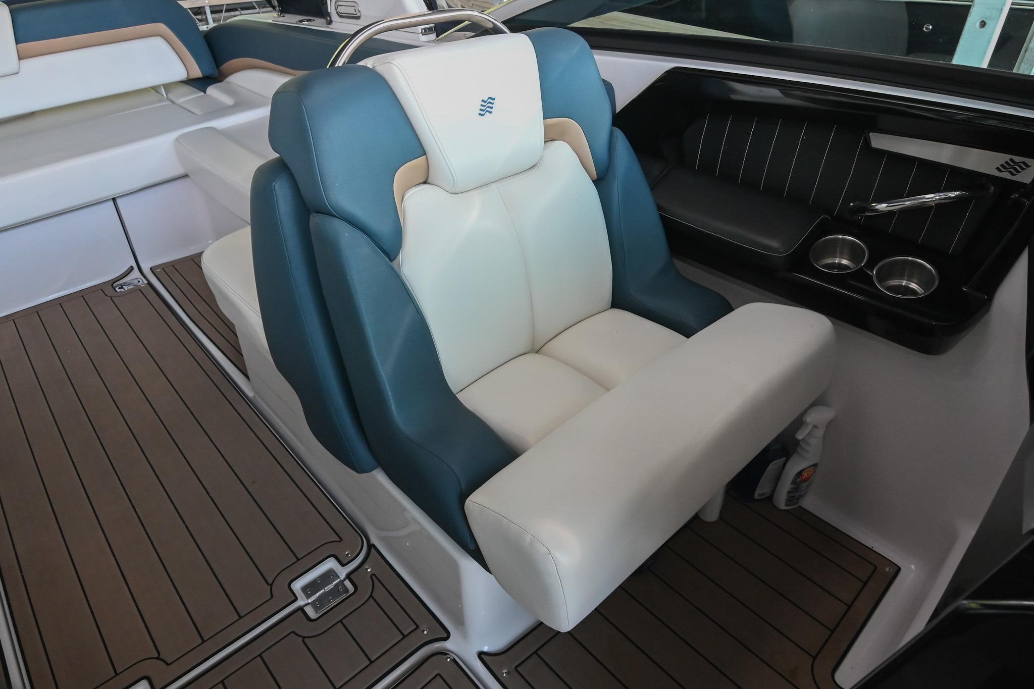 Luxury seating on 2014 Four Winns H290 boat with elegant design and cup holders.
