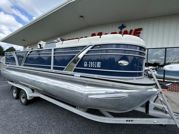 2020 Veranda VP22VLC pontoon boat on trailer outside a building.