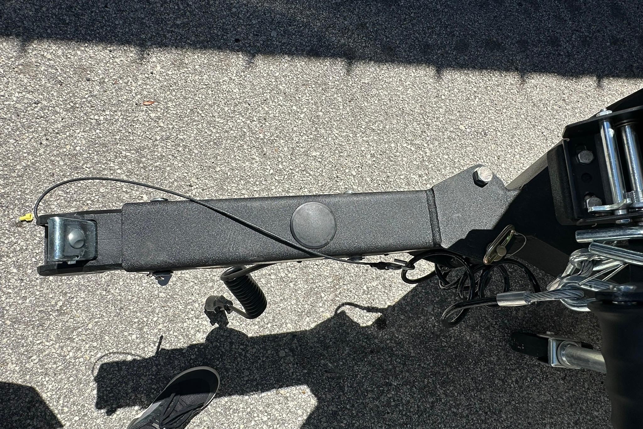 Trailer hitch of a 2026 Vexus AVX1880 on asphalt surface.