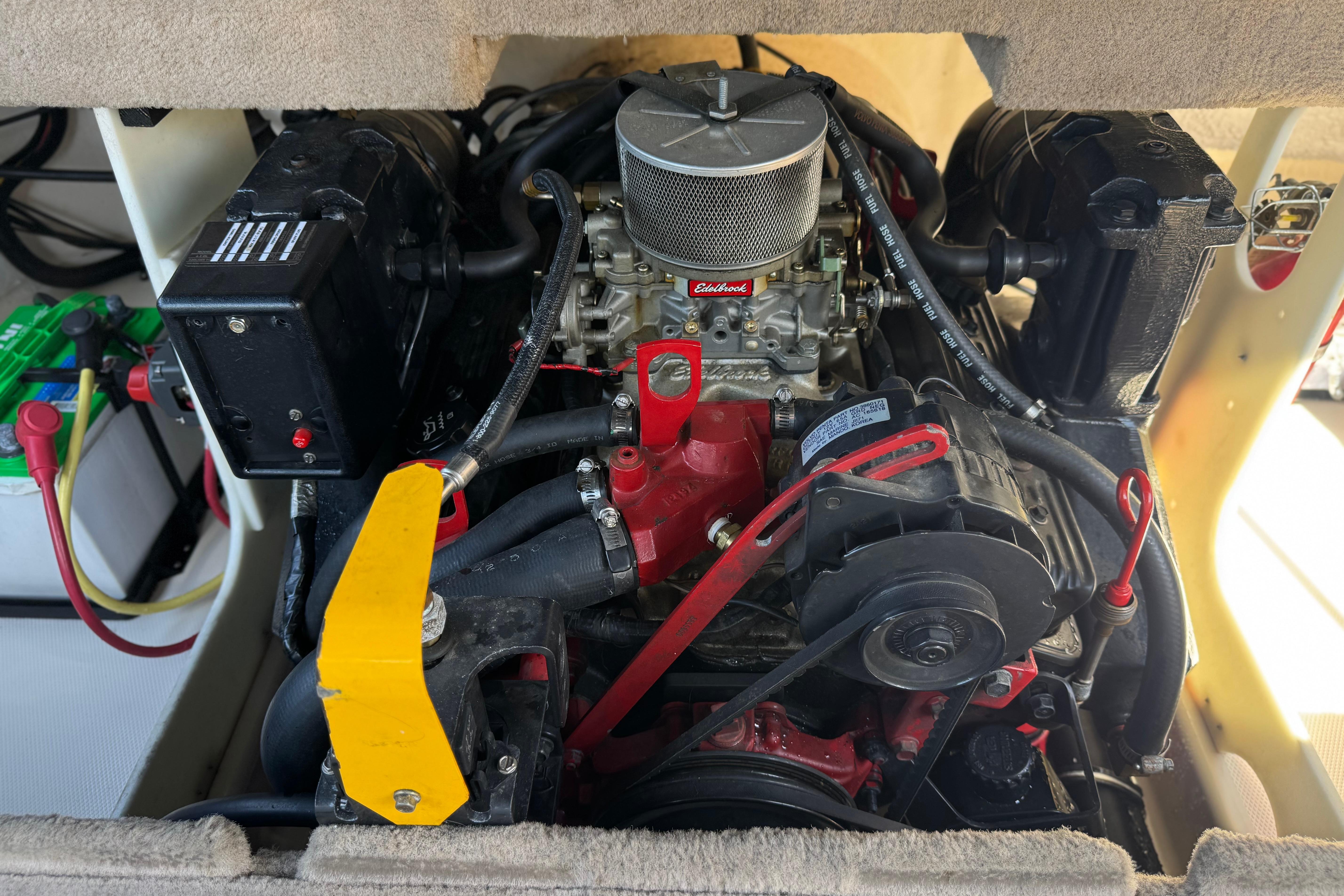 Engine compartment of a 2002 Chaparral 186 SSi boat, featuring an Edelbrock carburetor.