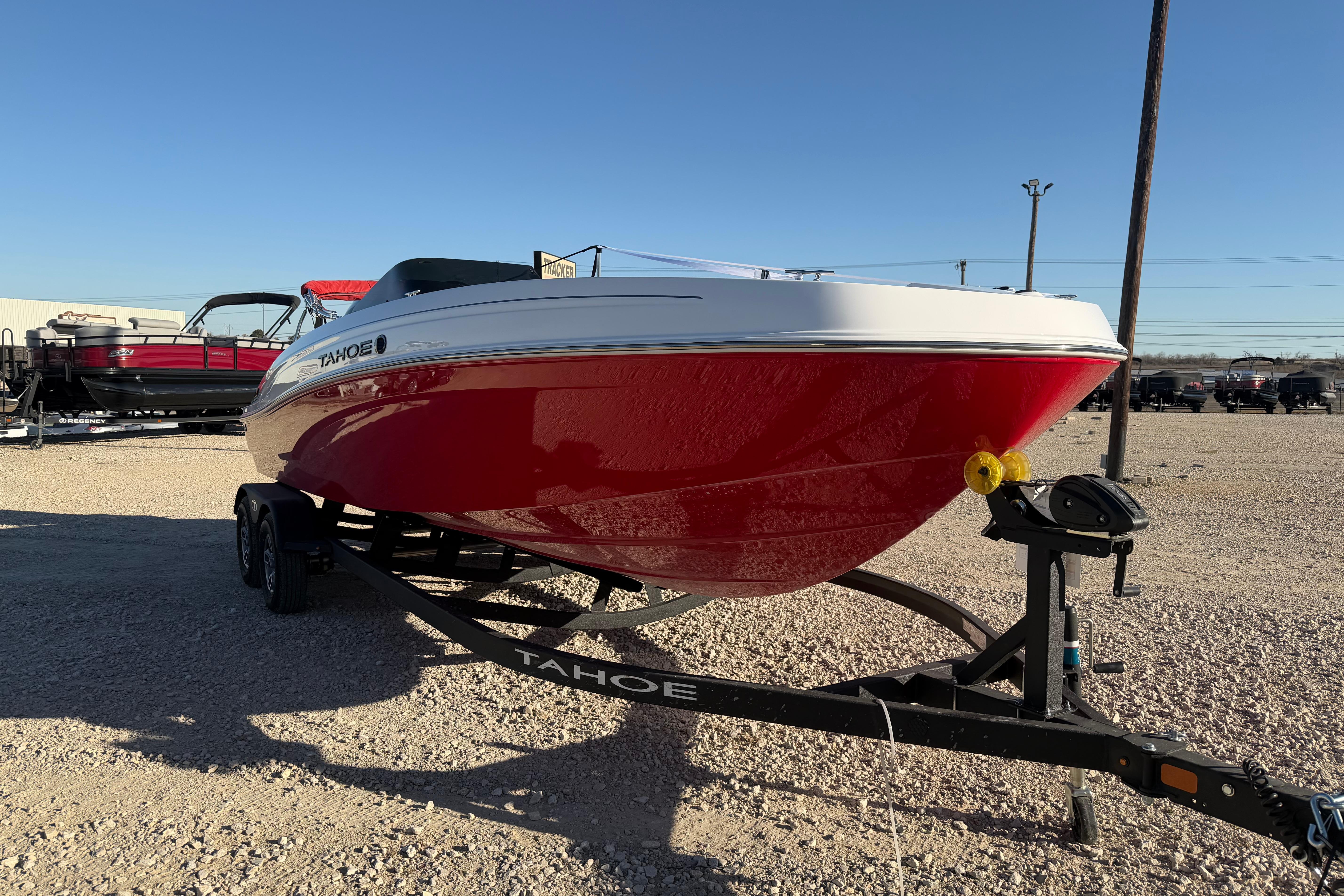 2026 Tahoe T21 boat with red hull on trailer in outdoor setting.