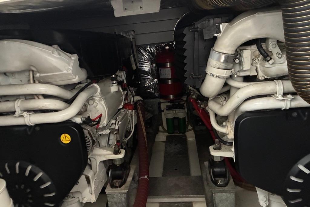 Engine room of a 2008 Sealine T50 yacht, showcasing dual engines and piping.