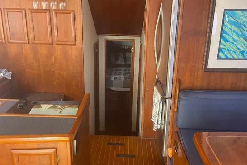 Interior of 1987 Topaz 44 Flybridge yacht with wood paneling and cozy cabin.