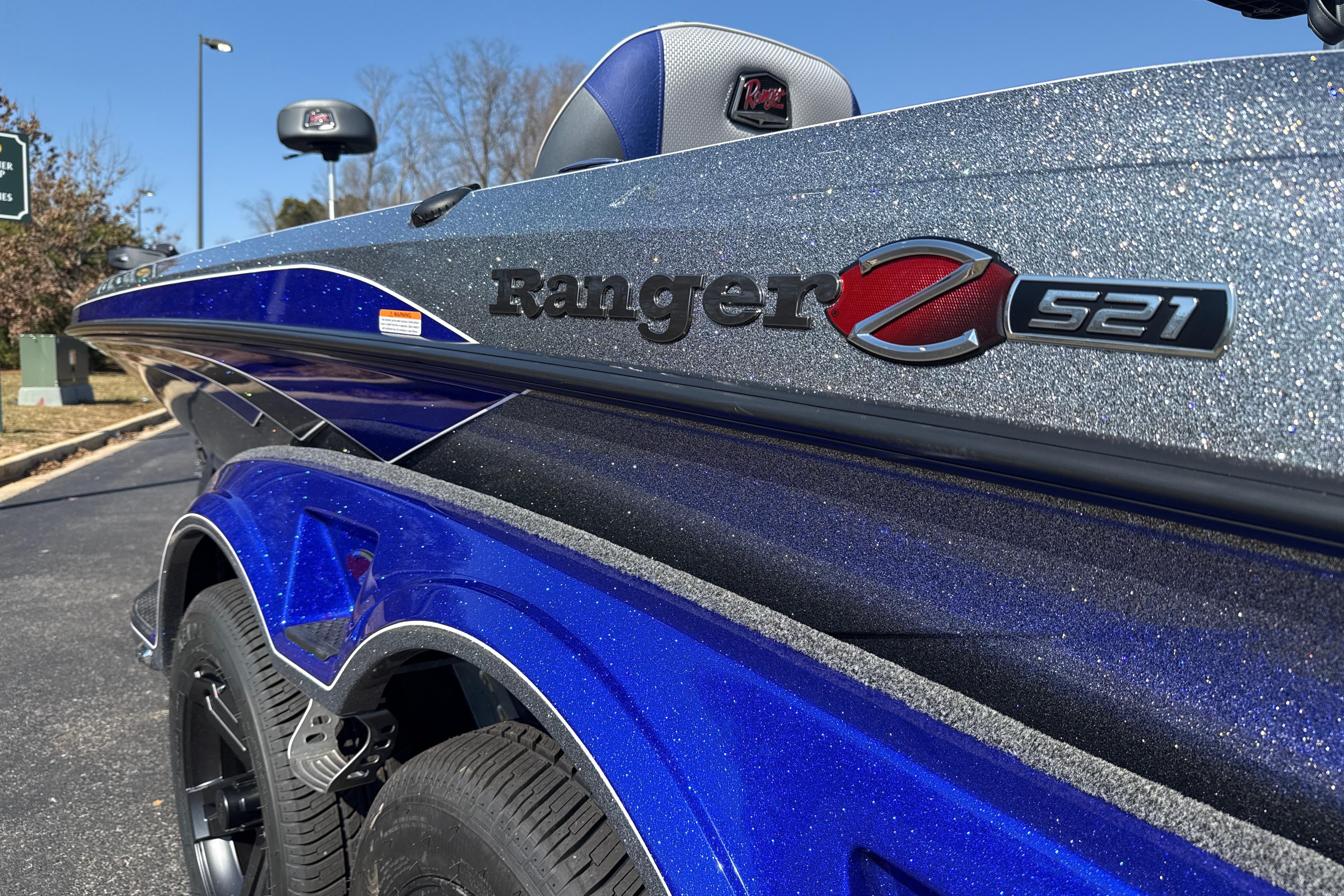 2026 Ranger Z521 boat with metallic blue finish, parked outdoors.
