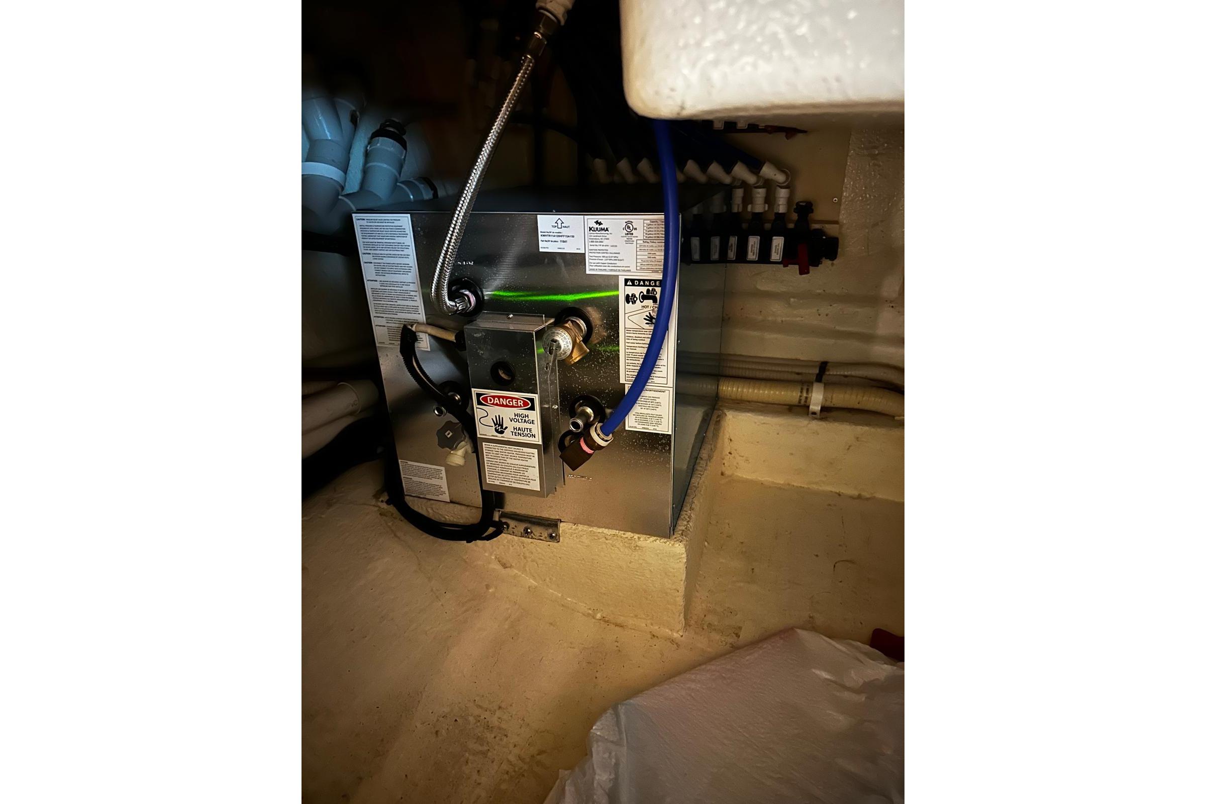 Engine room of 2012 Riviera 43 Flybridge yacht, featuring mechanical equipment and wiring.