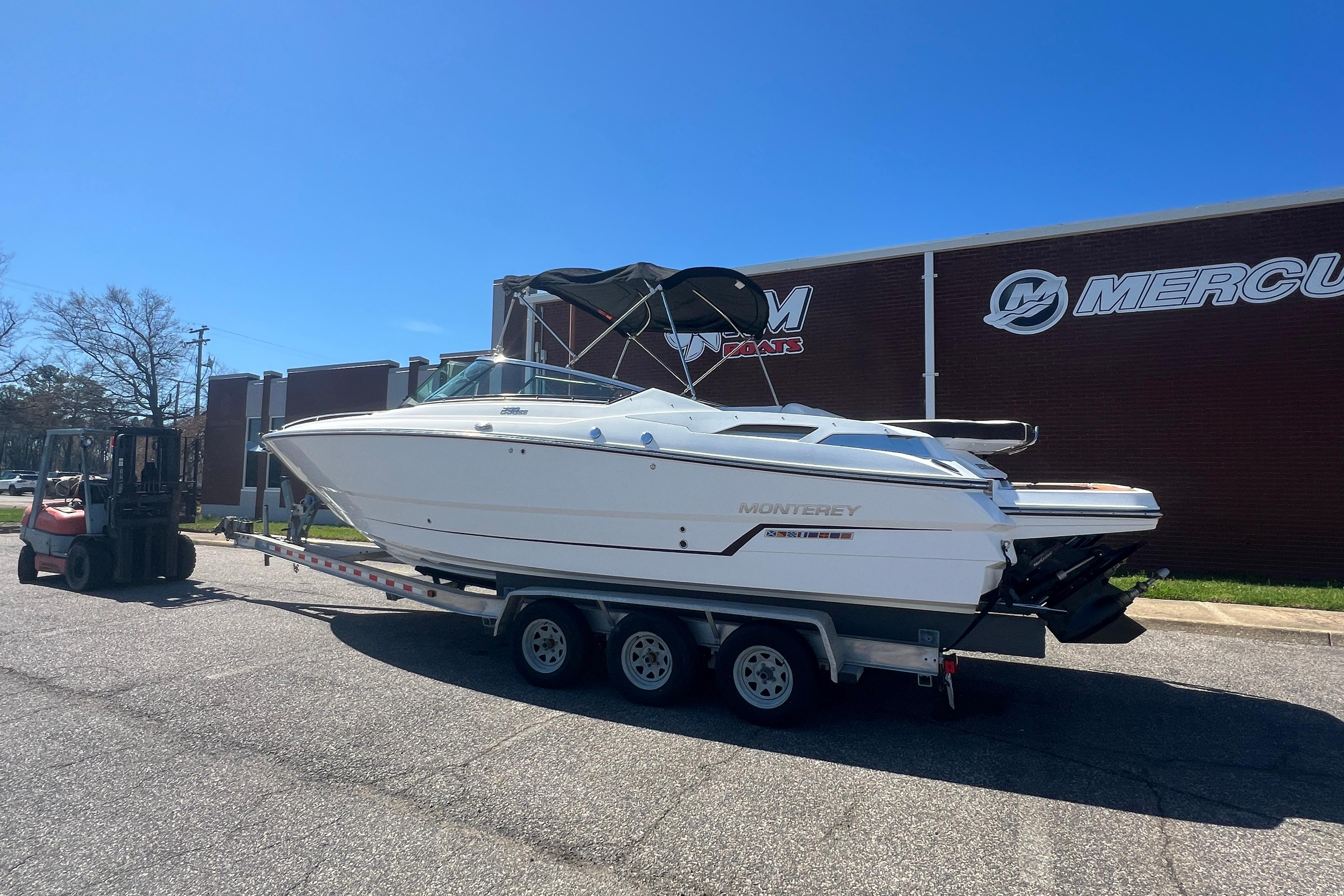 2017 Monterey 298SS Super Sport boat on trailer, parked outside a building.
