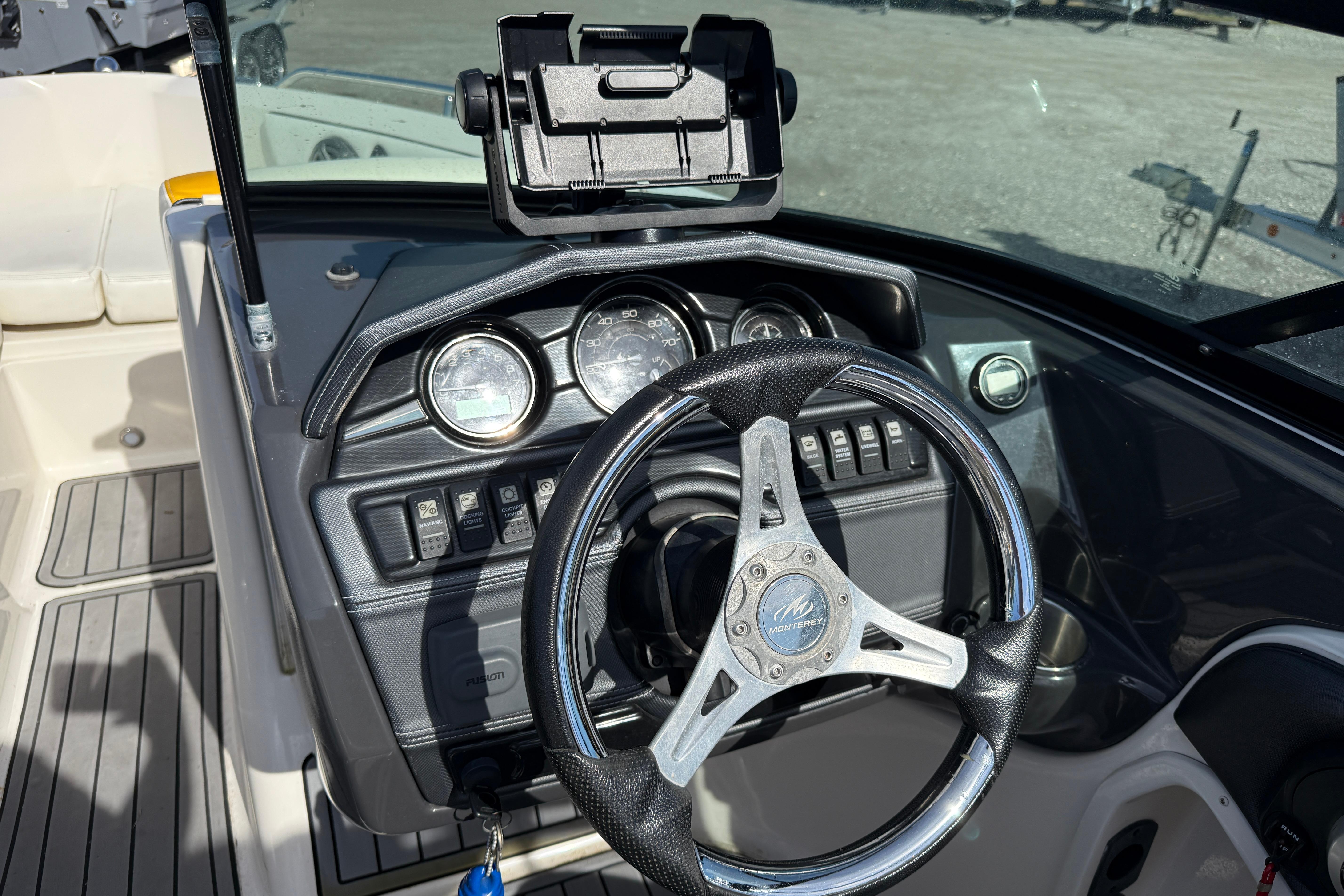 Steering console of a 2014 Monterey 197 Blackfin boat with gauges and controls.