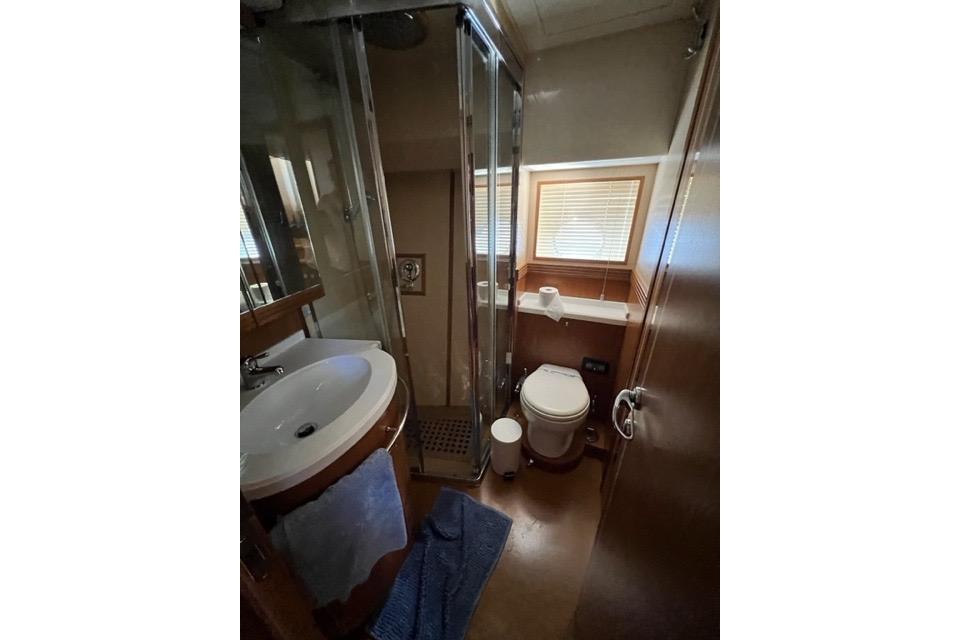 Luxurious bathroom in 2008 Apreamare Maestro 65 yacht with shower, sink, and toilet.