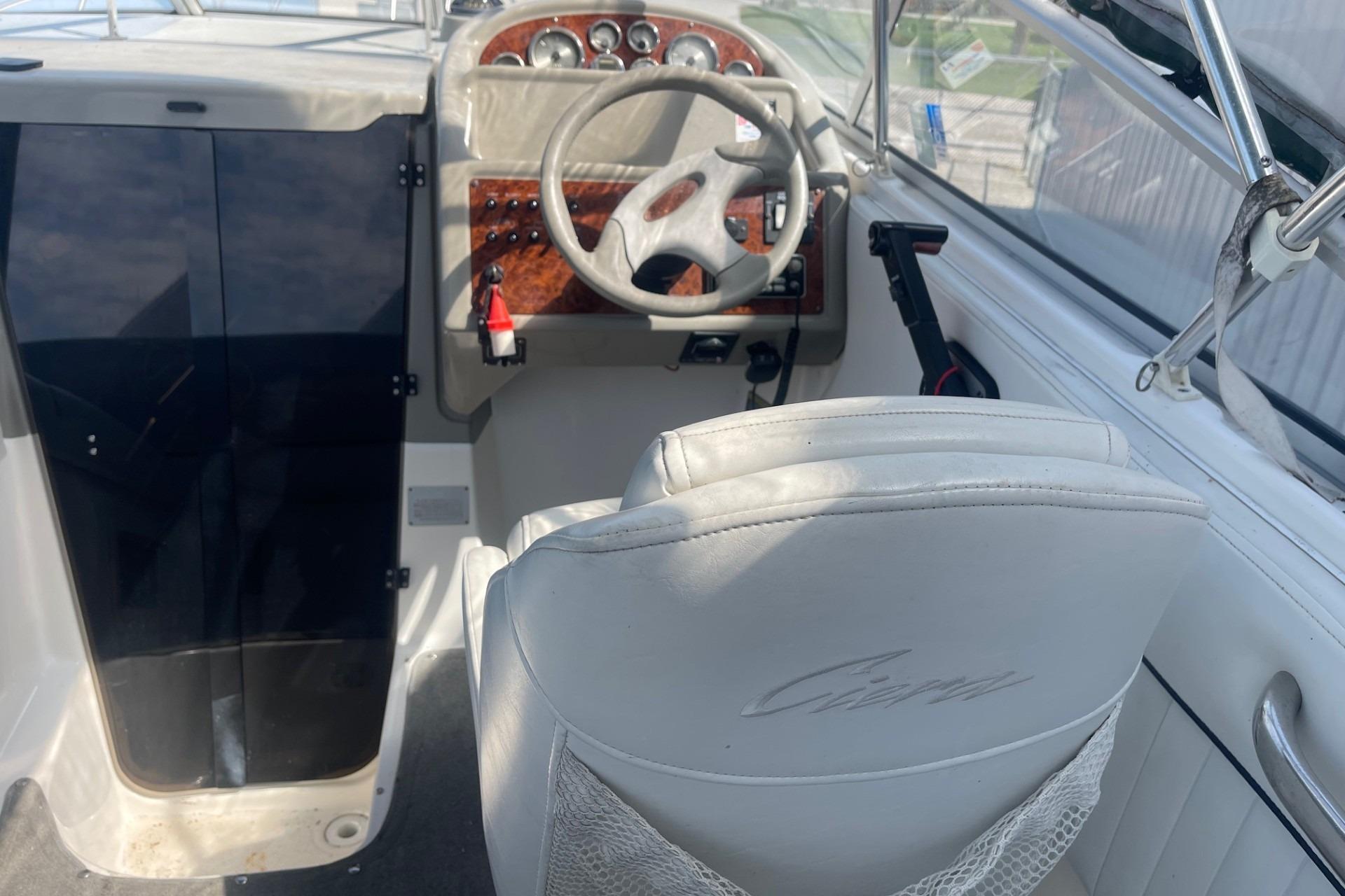 1997 Bayliner 2655 Ciera cockpit with steering wheel and control panel.