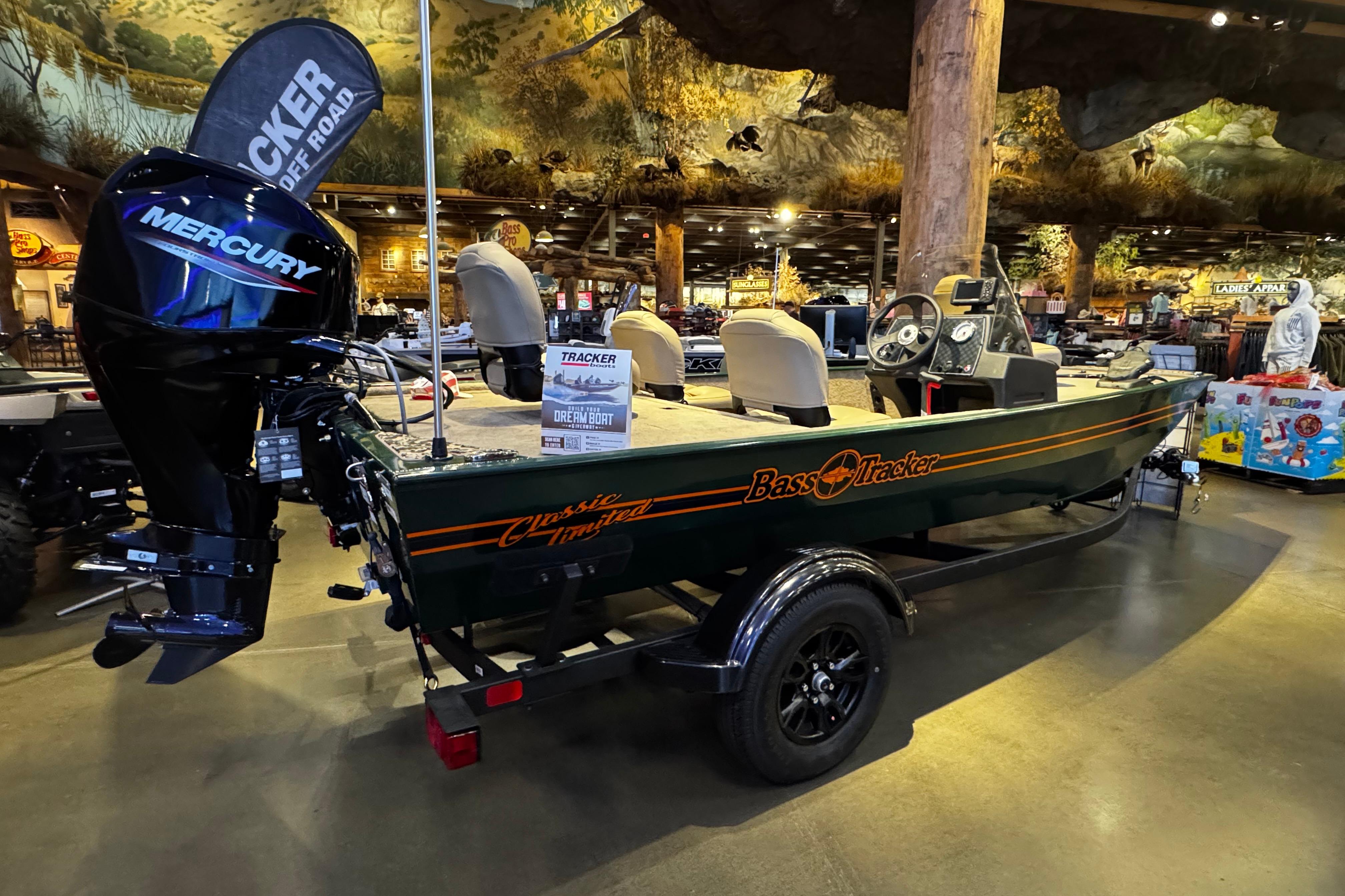 2026 Tracker Bass Tracker Classic Limited boat displayed indoors with Mercury engine.