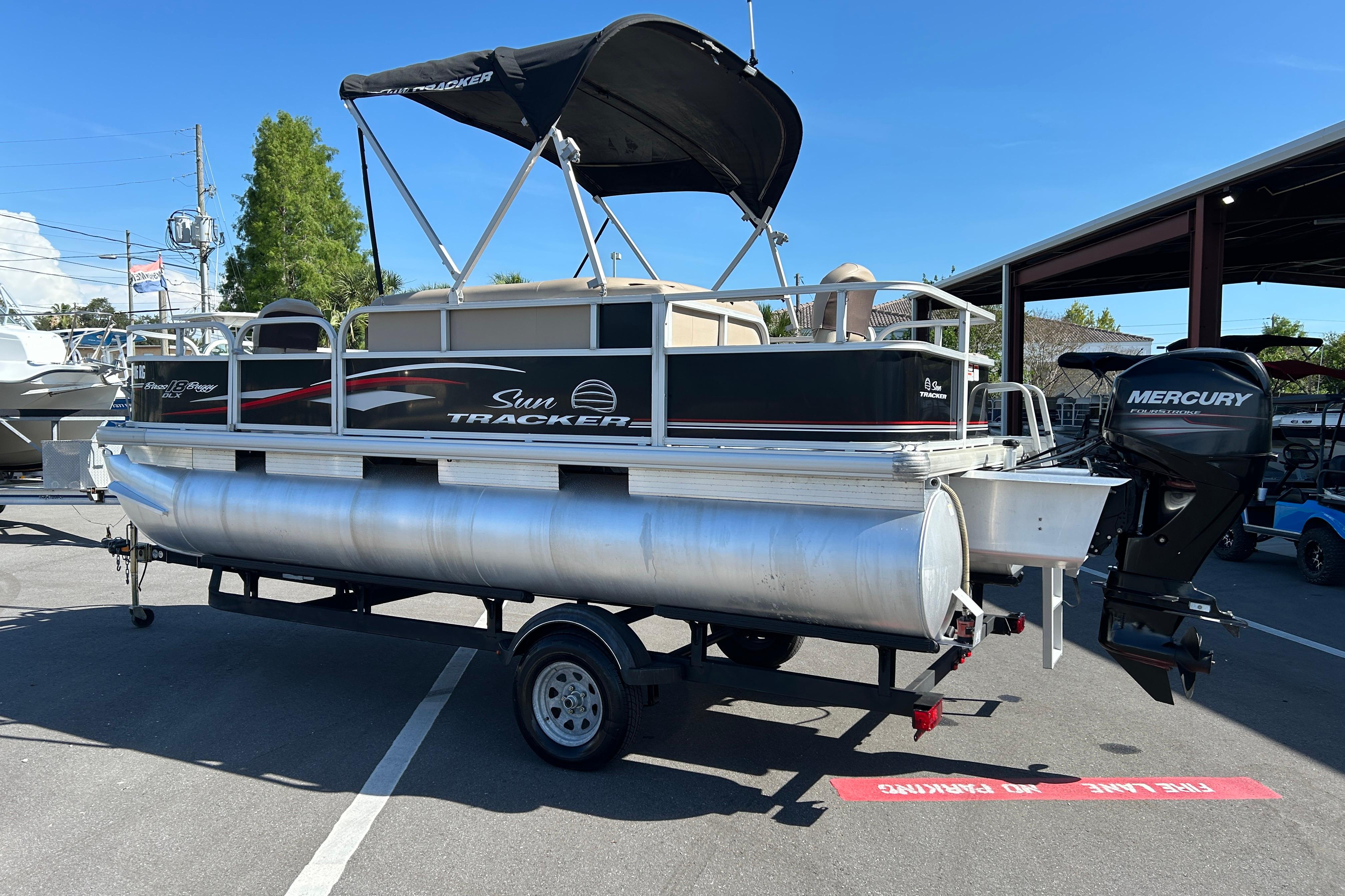 2017 Sun Tracker Bass Buggy 18 DLX pontoon boat with Mercury outboard motor on trailer.