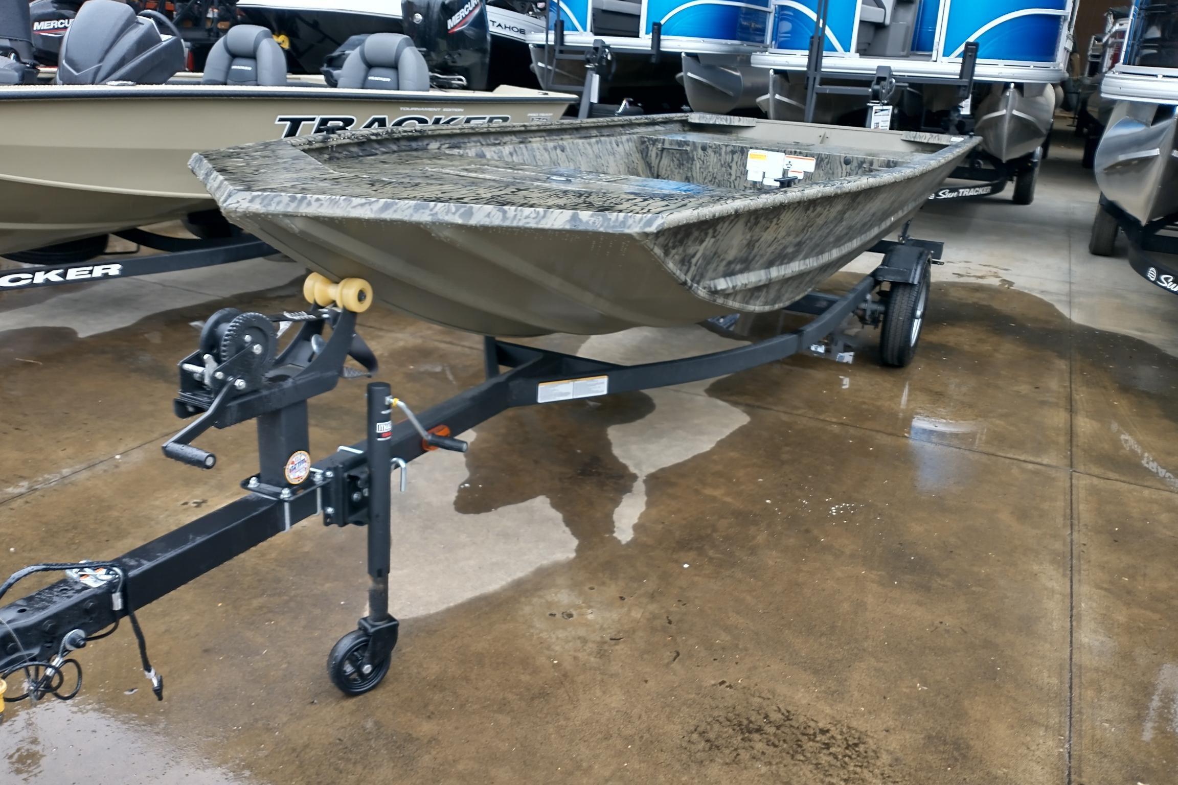 2026 Tracker Grizzly 1648 Utility boat on trailer, displayed in showroom.