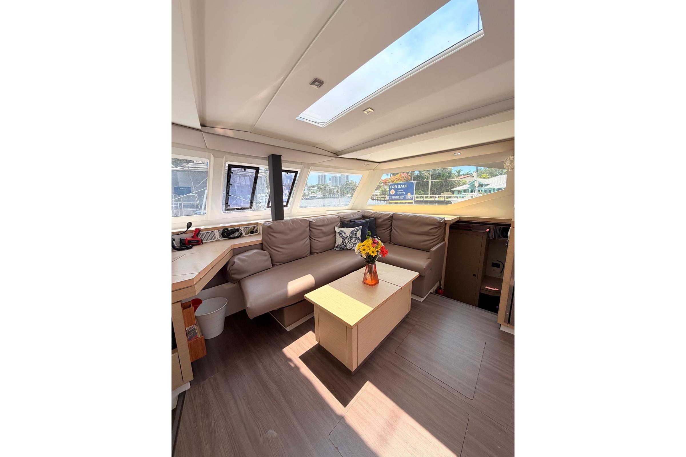 Interior of 2018 Fountaine Pajot Lucia 40 catamaran with cozy seating and skylight.