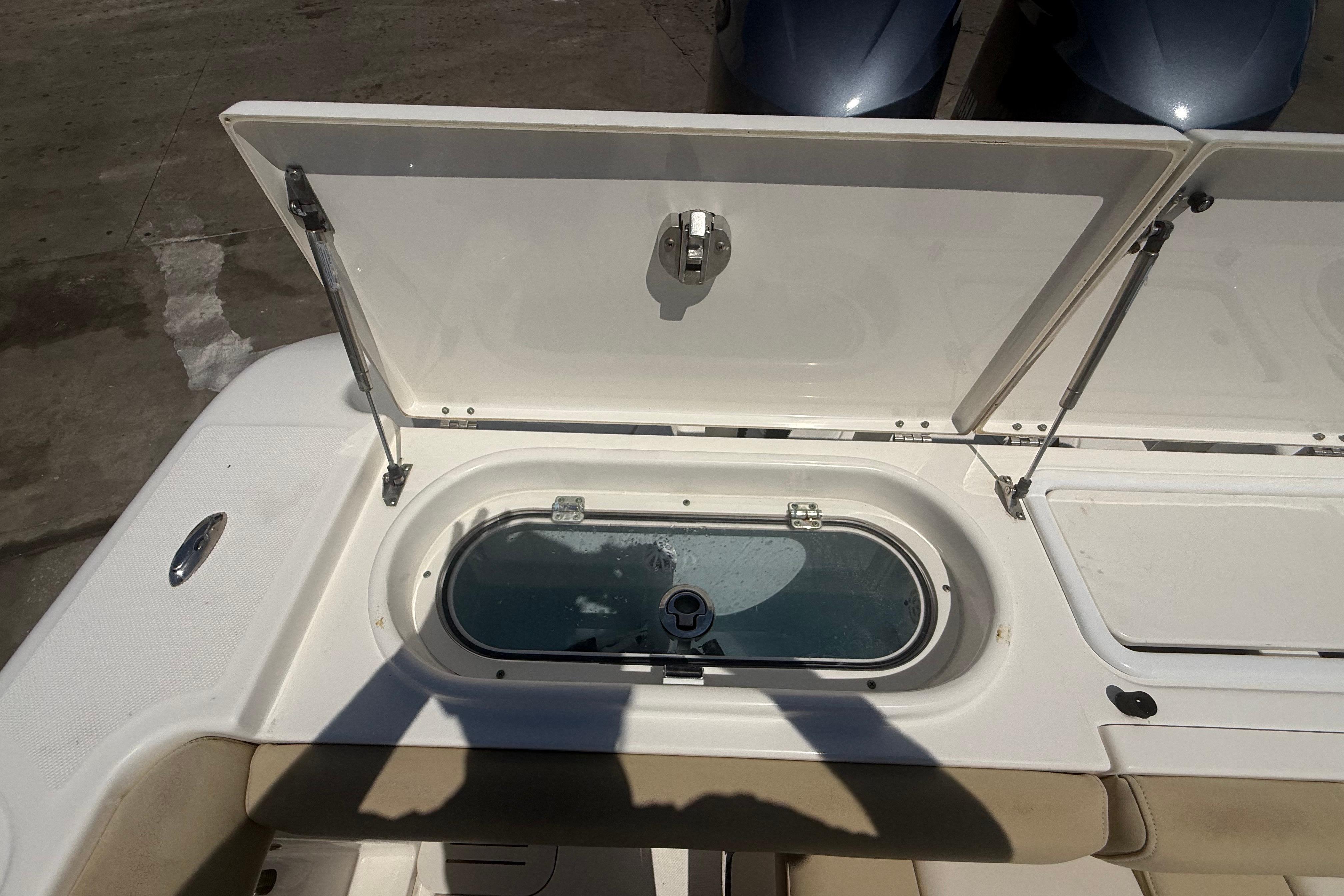 2019 Key West Billistic 281 Center Console livewell with open lid, showcasing interior features.