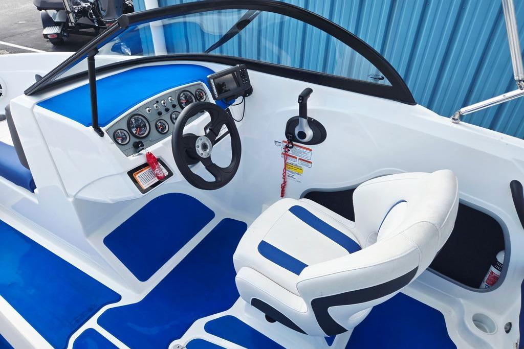 Cockpit of 2018 Tahoe 450 TS boat with blue and white seating and dashboard controls.