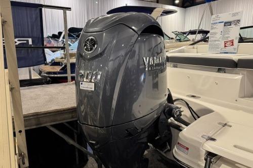 2026 Regal 21 OBX boat with Yamaha outboard motor displayed indoors.