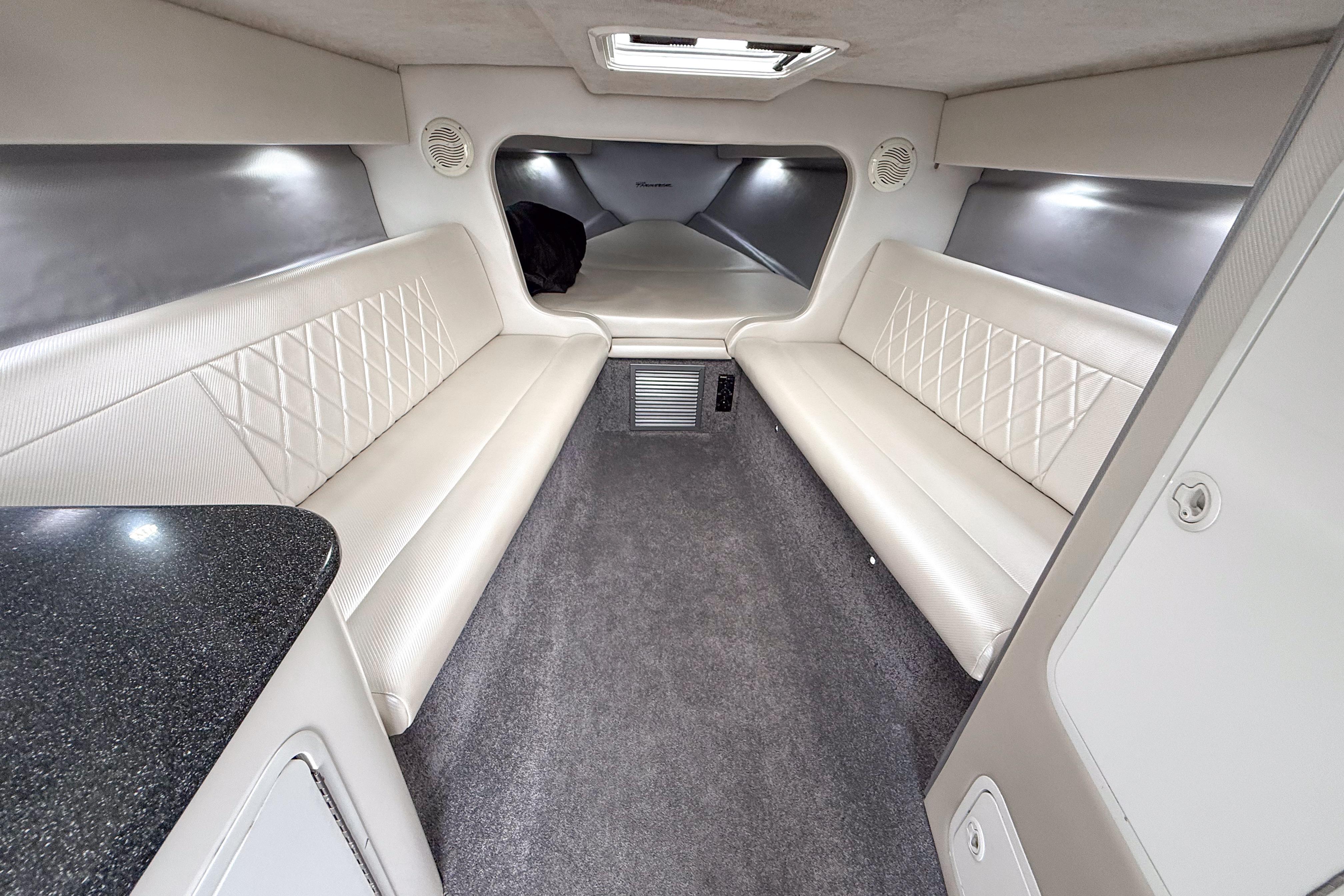 Luxurious interior of a 2002 Active Thunder 37 boat with white seating and modern design.
