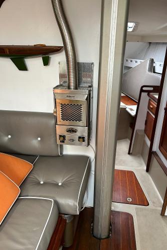Interior of a 1983 O'Day 39 sailboat with seating and a heater.