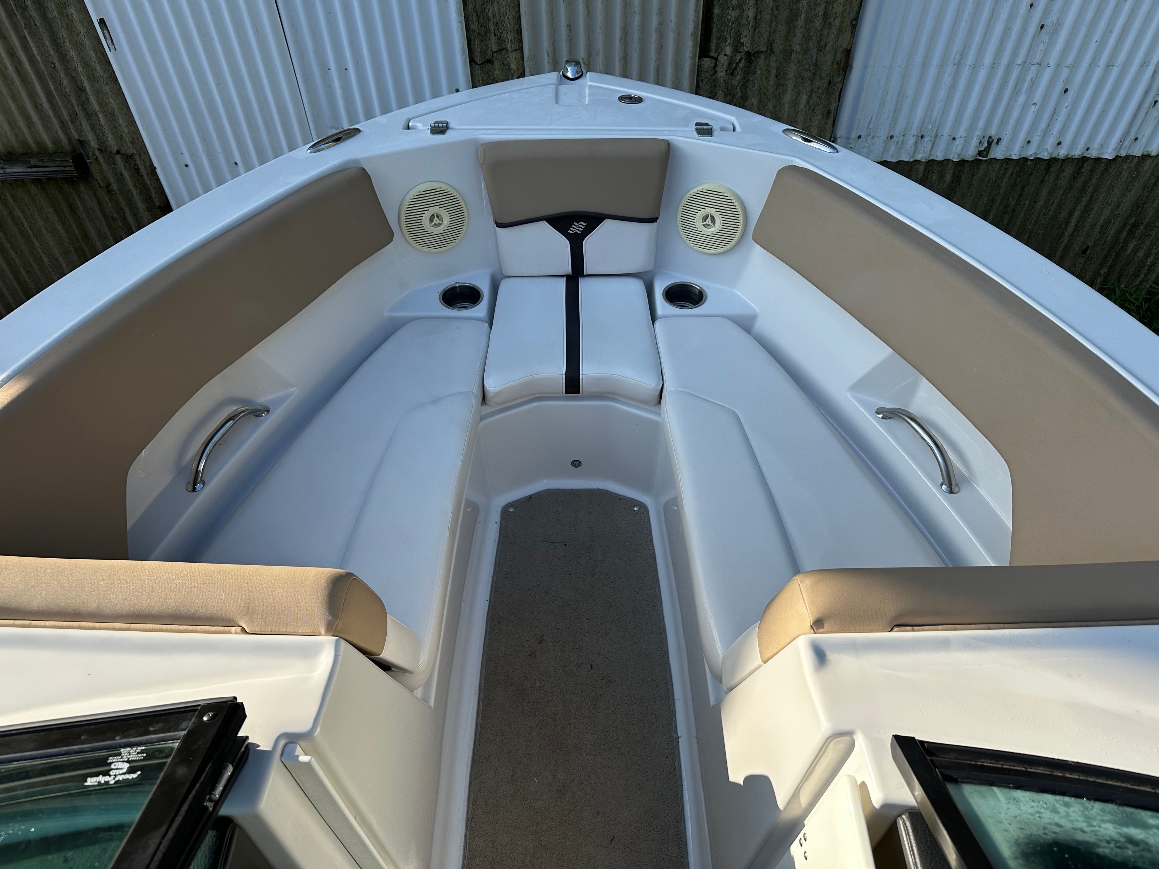 Interior view of a 2012 Four Winns H210 boat with seating area.