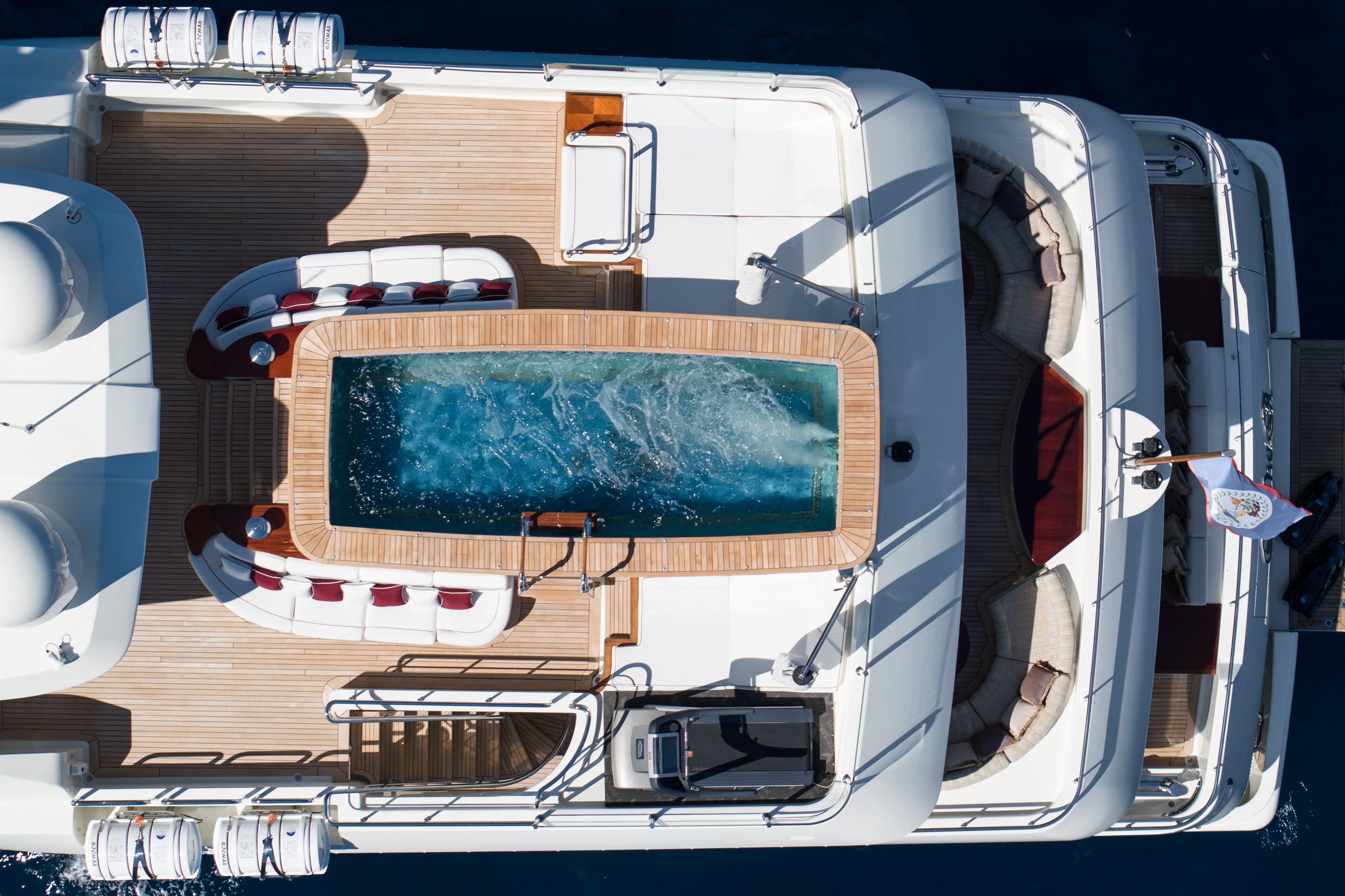 Luxurious 2008 CRN 185 yacht deck with pool and seating area, aerial view.