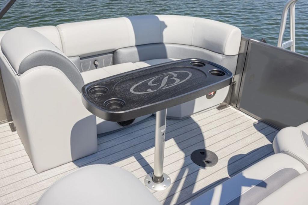 2026 Bentley Pontoons Legacy 223 Cruise interior with seating and table on water.