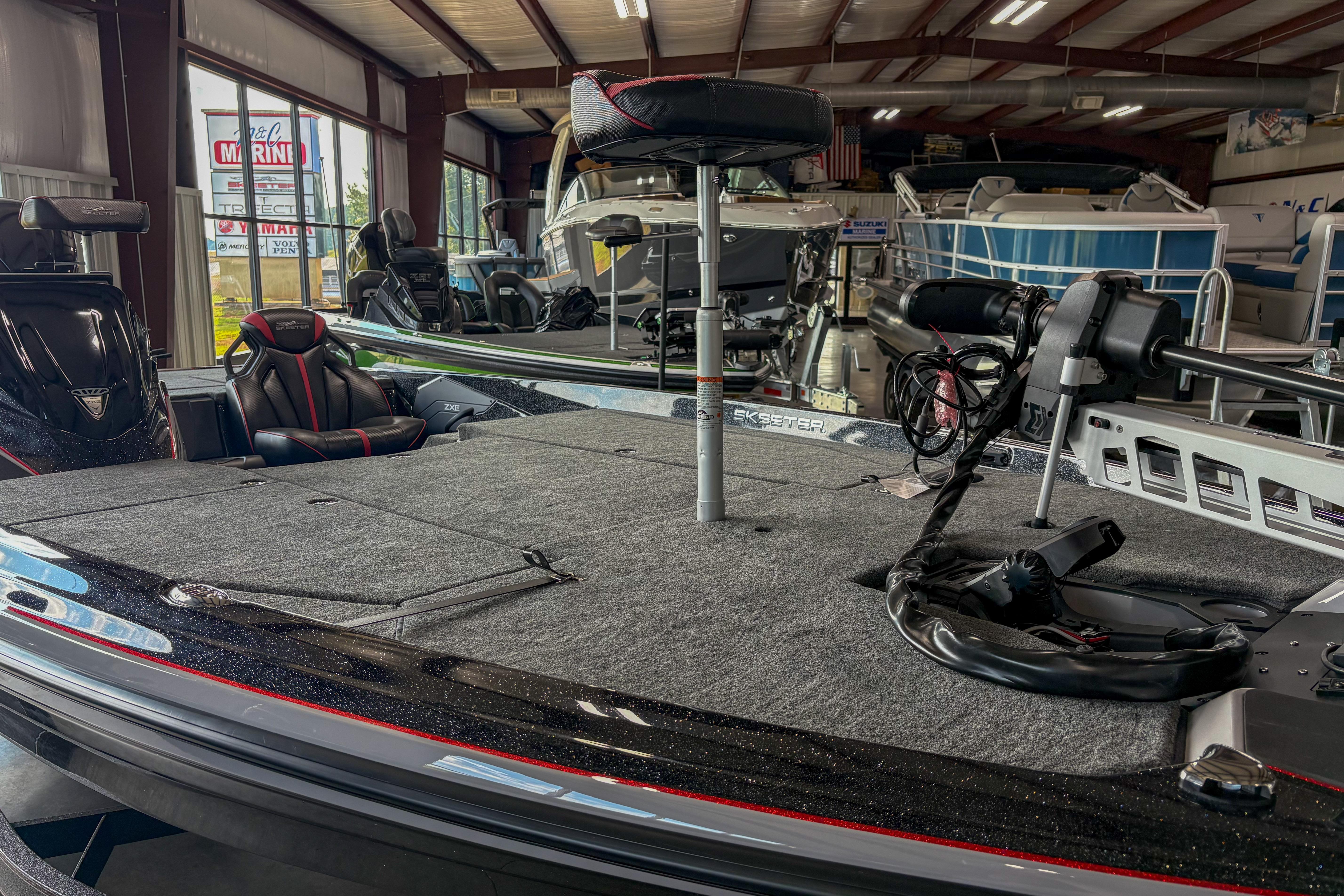 2026 Skeeter ZXE20 boat interior in showroom, featuring seating and equipment.