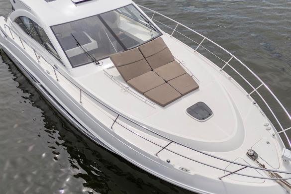 2016 Sea Ray Sundancer 510 yacht on water, featuring sleek design and sunbathing area.