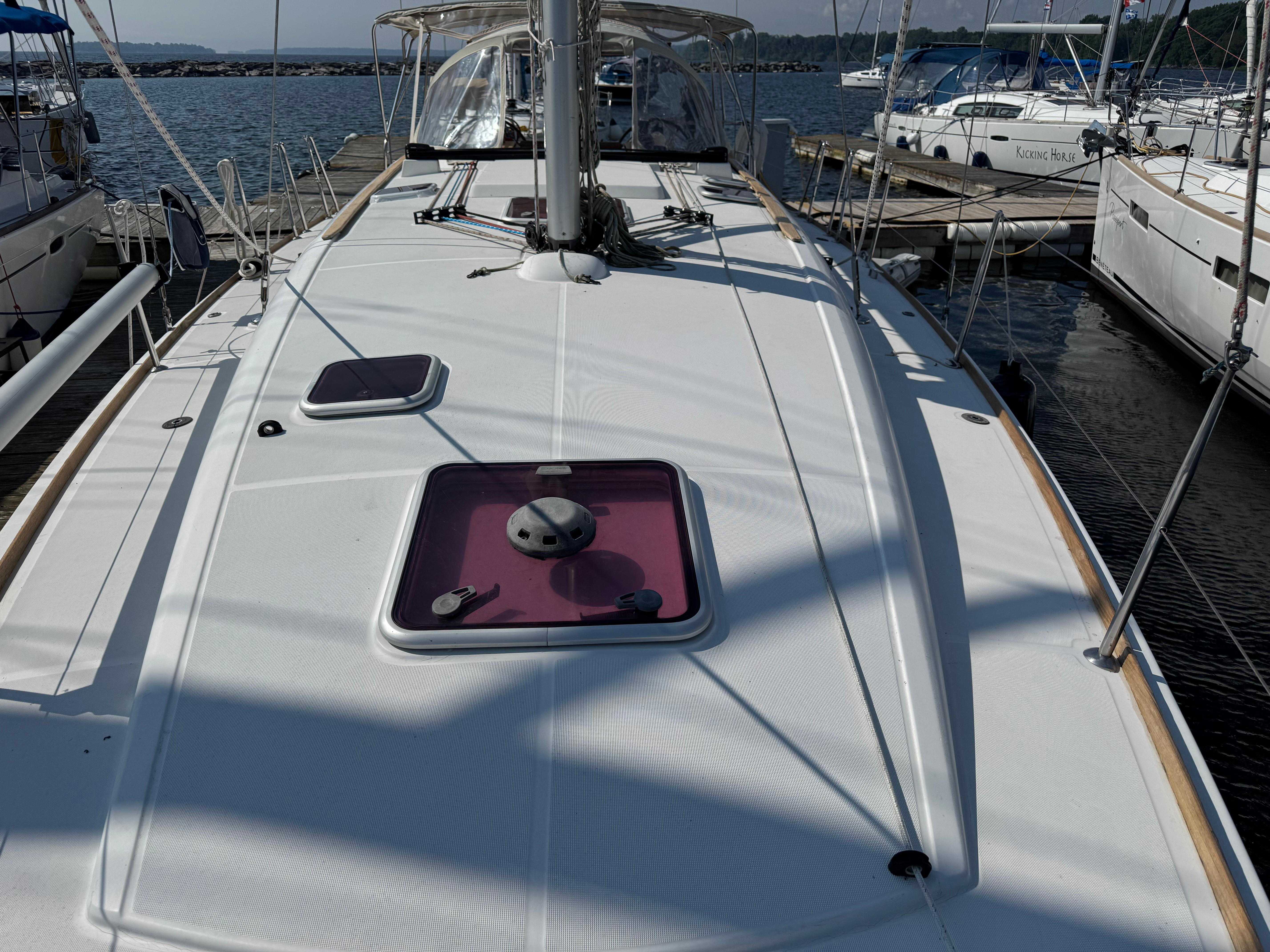 2008 Jeanneau Sun Odyssey 42 I sailboat docked at marina, showcasing deck and hatches.