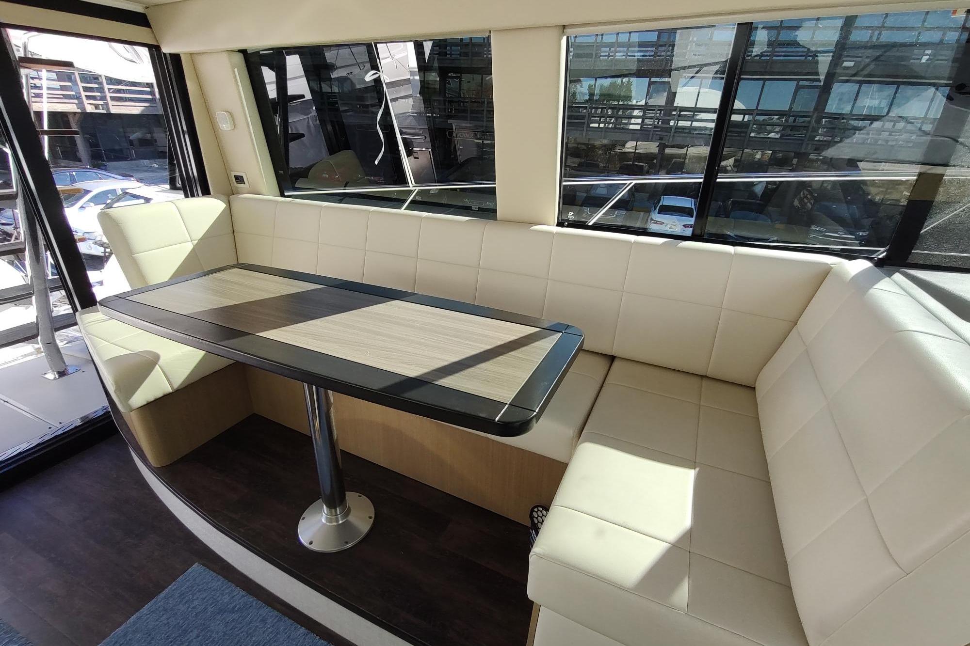 Luxurious interior of 2021 Regal 42 Fly yacht with elegant seating and table.