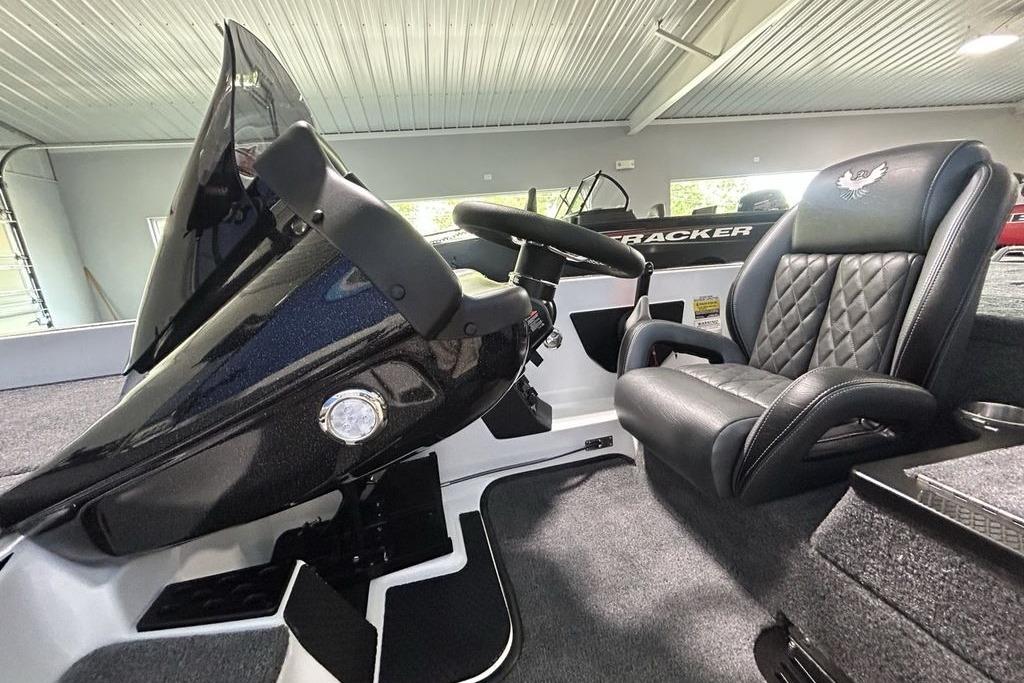 2026 Phoenix 818 Pro boat interior with steering wheel and cushioned seat.