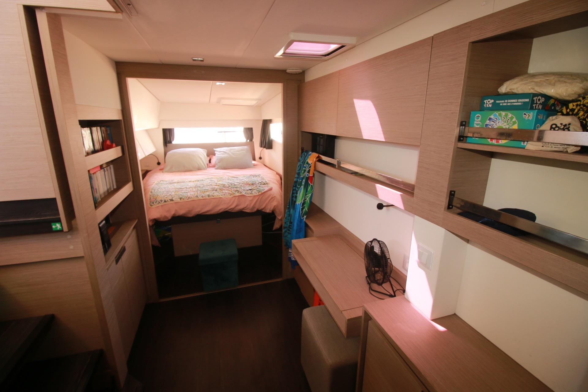 Luxurious interior of 2022 Fountaine Pajot Elba 45 Catamaran with cozy bedroom and modern amenities.