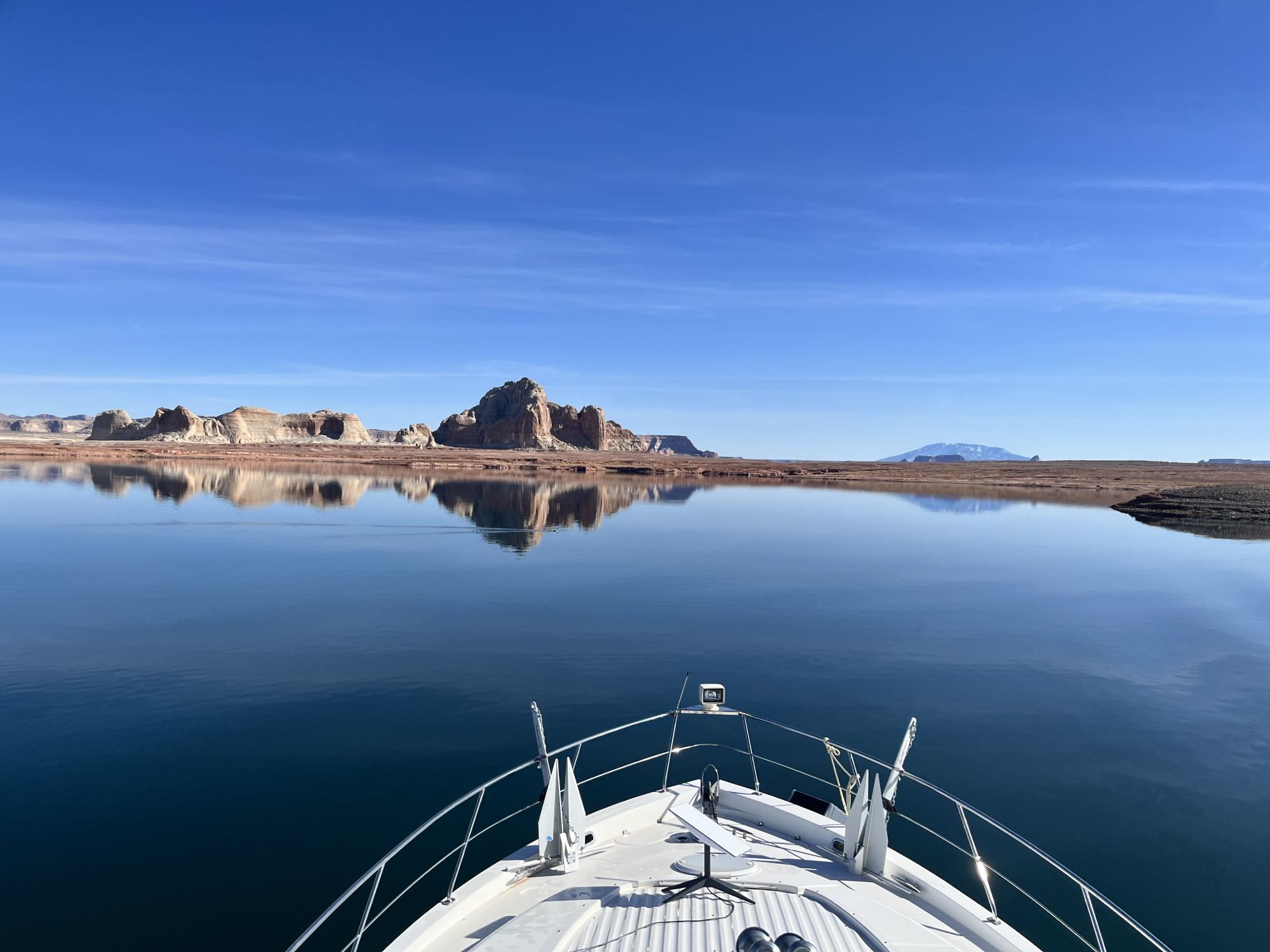 2002 Carver 506 Motor Yacht on calm water with rocky landscape in the background.