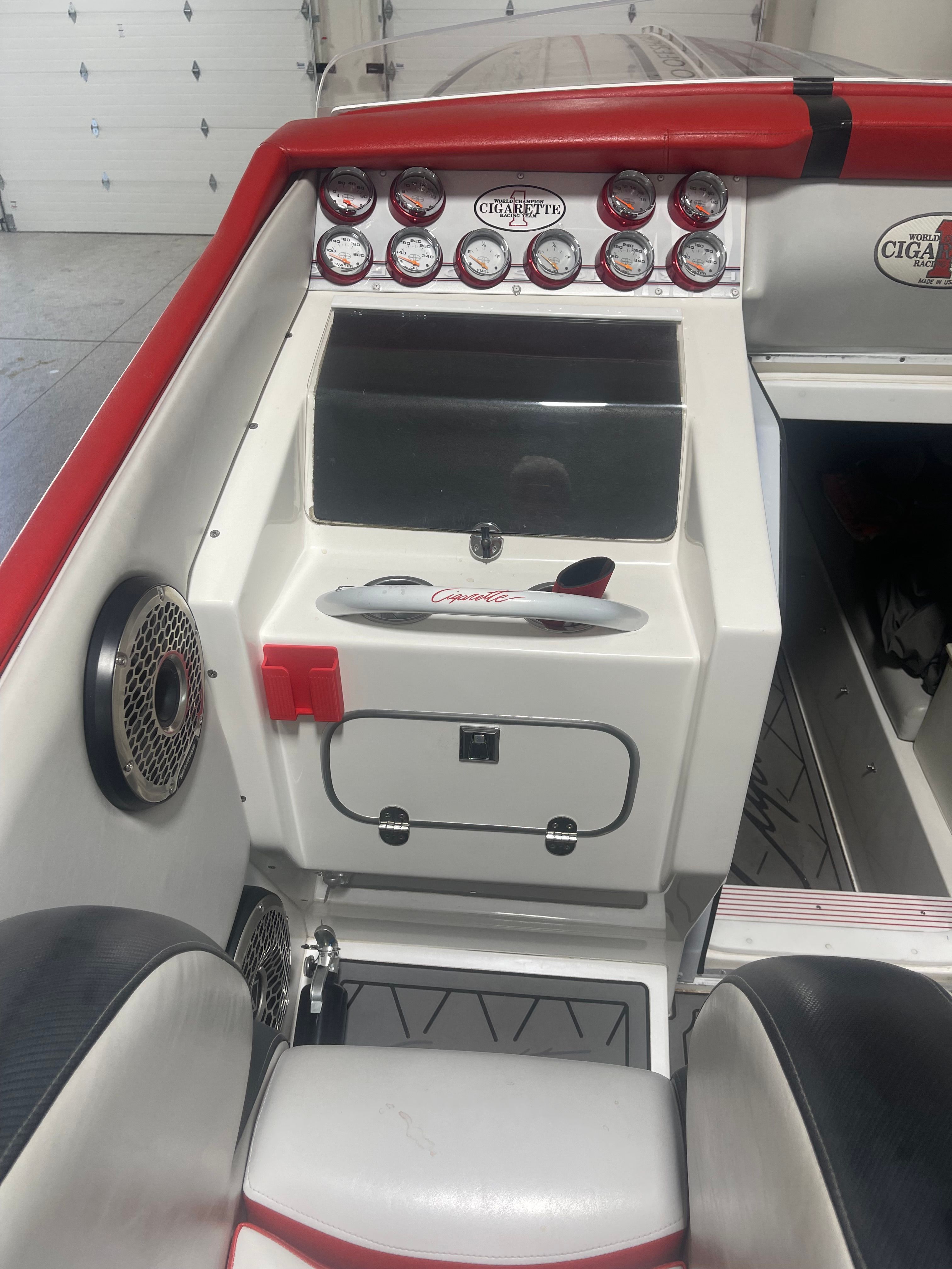Interior of a 2004 Cigarette 38' Top Gun boat with dashboard.