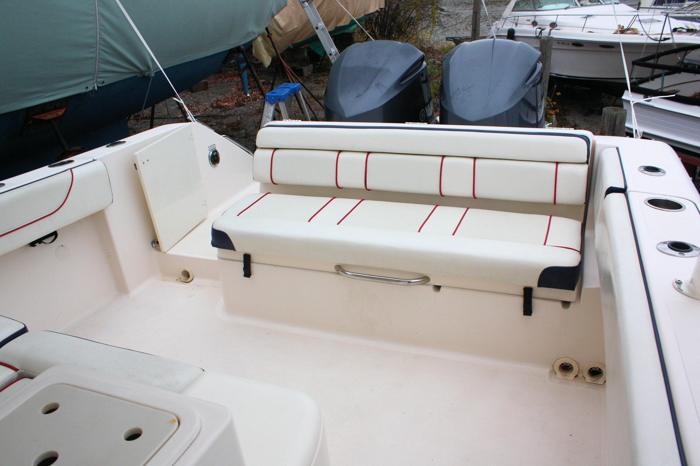 2013 Pursuit ST 310 Sport boat interior with cushioned seating and storage compartments.