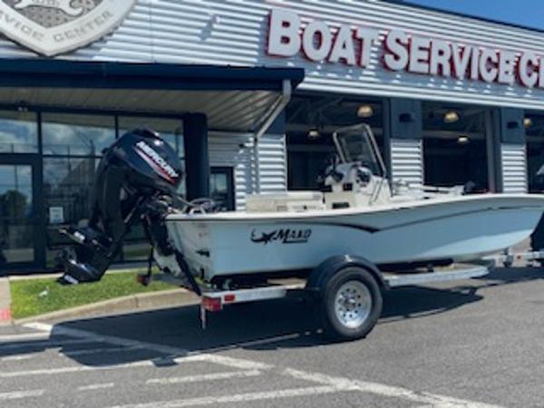 2024 Mako Pro Skiff 15 CC boat on trailer outside service center.